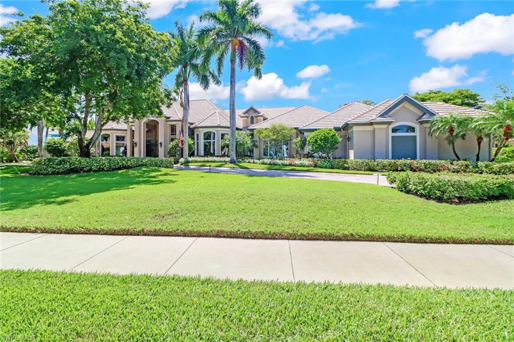 From the moment you walk into this phenomenal estate home you’re greeted by sliding glass doors that open to an expansive pool area and view of an 11-acre lake.  This 4 bedroom home features high ceilings throughout, formal dining room, a ton of natural light, 3-Car and 1-golf cart attached garages, very large covered and screened-in Lanai with pool spa and drop down bar and kitchen. The southeastern view gives you sun all day on your pool. A new roof was just installed last year and the generator for the home makes for "no worries" if power goes out! Quail West Country Club is an elite community with a multitude of amenities like tennis, pickle ball, golf, beauty salon, 2-story fitness facility, restaurants and so much more.