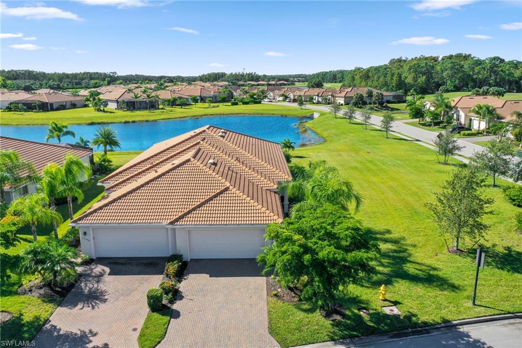 Welcome to this charming villa, formerly a model home, that is sure to capture your heart. This meticulously designed property boasts a perfect size, featuring 2 bedrooms and a den. Situated on a sprawling corner lot, it offers an abundance of green space. The screened-in lanai provides a tranquil water view, complemented by the convenience of an electric storm smart shutter with ample room to enlarge the lanai or even install a pool. Professionally decorated, the villa's furniture is negotiable. The 18" diagonal tile flooring adds a touch of elegance. Built ins in the closets and  double sinks in the master.  The kitchen is a bright and inviting space, adorned with white cabinets and a window that fills the room with natural light. Pelican Preserve is a highly sought-after community for adults aged 55+.  This vibrant community offers an array of amenities, including pickle ball, tennis, bocce ball, theaters, outdoor concerts, a spa, fitness center, and walking trails and more! To top it all off, Pelican Preserve boasts 27 holes of fantastic golf, with optional memberships available. Embrace the Florida Lifestyle and start enjoying all that this remarkable community has to offer.