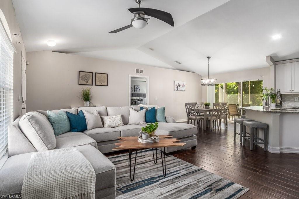 This spacious 1800 sq ft, 4 bed + den/2 bath home features many updates and is ready for you to move in! INCLUDES 1 YEAR HOMEOWNER'S WARRANTY! Kitchen was fully updated in 2016 and includes 42" custom white kitchen cabinets, granite countertops, and tile backsplash. Modern color palette with dark-toned wood tile flooring flows through the kitchen, main living area and bathrooms, carpeted bedrooms, and soft, neutral paint tones throughout.  Both bathroom vanities (updated in 2018) have granite countertops and brushed chrome fixtures. The garage was converted into a separate living space featuring a large living room and bedroom, ideal for an in-law suite, teens, or guests. Enjoy the privacy of your 1+ acres of land from your screened lanai. 10’ x 10’ shed pictured conveys with the property. With a desirable location just 2 street from Golden Gate Blvd, this home is in the heart of all the growth happening in Golden Gate Estates.