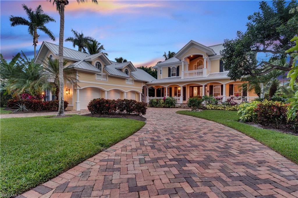 Located just a block from pristine Naples beaches, this two-story Olde Naples home offers a coastal, Southern charm with wraparound porch, wood flooring, detailed millwork and stunning lake views. An Art Canada home, no detail has been overlooked in the design. The windows frame beautiful Florida fauna and streaming sunlight creating a serene and private retreat. The kitchen is a chef’s domain with espresso machine, wine fridge, large island, gas cooktop, two dishwashers and a butler’s pantry. Entertain with ease with a large dining room and a great room that opens to a lanai with screened porch, pool and spa and glistening lake views - perfect for enjoying the Gulf breezes. The backyard is fully fenced for four-legged family members. The second floor living space includes a spacious master suite with a sunroom and deck overlooking the lake. A private guest suite, including living area and kitchenette, has its own entrance above the three-car garage. This is the perfect location to entertain family and friends and embrace the Florida lifestyle.