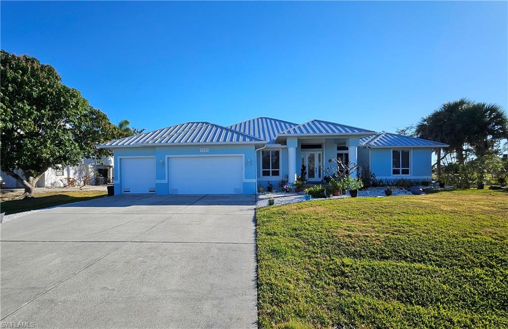Stunning Single Story 2619 SF Pool Home with a Den plus 3 Car Garage sitting on a 15,000 SF Lot (.34 of an acre). Enjoy weekend BBQ's plus amazing nightly sunset views from your peaceful lakefront island retreat with the sun splashed gulf waters less than a mile away. Only a few minutes drive from the more than 10 Island Restaurants located on Matlacha and Pine Island, many having tiki hut bars, nightly live island music and fresh seafood served daily. Island Time awaits for those seeking water adventures or a complete laid back lifestyle.
Recent Upgrades and Features: 
Brand New Modern Seam Metal 16" Panel Width Roof installed in 2024 (40+ year roof lifespan). Kidney Shaped Swimming Pool recently renovated in 2024 with new tiles and a pebbletec flooring, multi-colored pool light and a new Pool Pump. Spacious Modern Den with a front window just beside the living room with wood/glass pocket doors, great for those who work from home. Panorama Outdoor Screened-in Pool Patio giving you an unobstructed view of the lake from your living room. 84" High 4-Panel Multi-Slide Glass Doors open up the Living Room to the Lanai, a nice feature to have for those big parties with family & friends. (3) Power Remote Control Stormsmart Fabric Roll-Down Hurricane Shutters protecting the entire Lanai Area from  Storms (prevents up to 150+ mph winds). Extended 3 Car Garage with a back door plus parking for up to 7 cars in the extra long driveway. Must see this home in person to really appreciate it's stylish beauty, southwestern appeal and host of valuable upgrades.