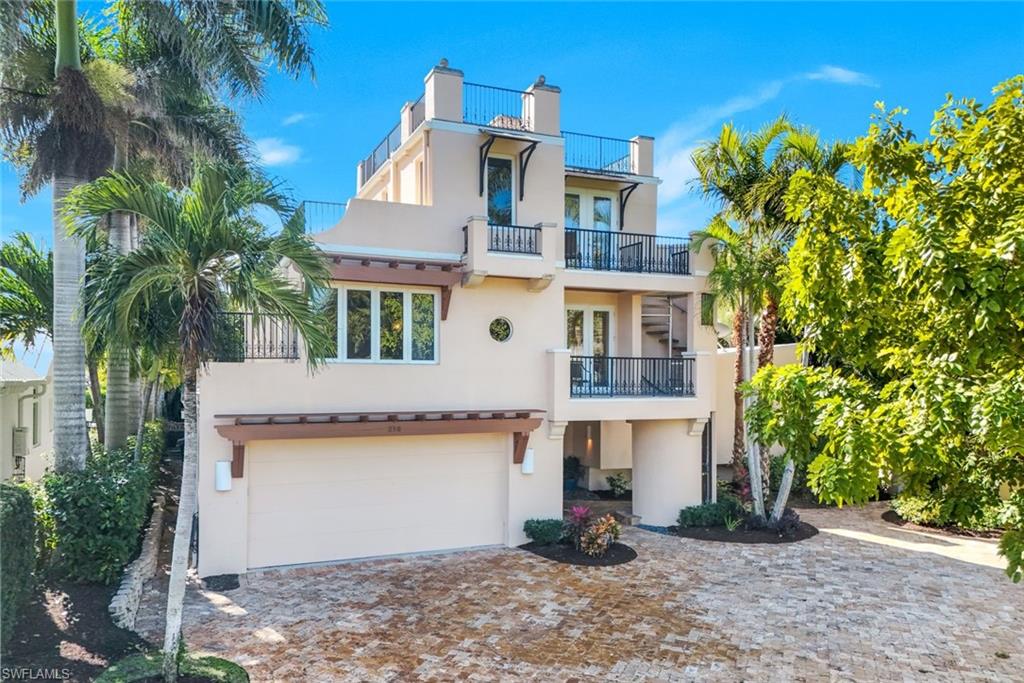 Welcome to your private tropical sanctuary in the heart of Olde Naples.

Just five homes from the sugar-white sands and turquoise waters of the Gulf, this extraordinary luxury estate delivers the ultimate Naples escape—where timeless coastal elegance meets effortless resort-style living. Hidden behind lush tropical landscaping on an oversized corner homesite, this remarkable residence feels like your own private boutique resort designed for unforgettable moments with family and friends.

Spanning three beautifully designed levels, this exceptional retreat offers five luxurious bedroom suites, each with direct bathroom access—creating the perfect balance of connection, comfort, and privacy for every guest. Whether gathering across generations or celebrating with friends, every space has been thoughtfully designed to elevate your stay.

The first-floor primary suite serves as a peaceful private sanctuary featuring a spa-inspired bath and direct access to the serene outdoor living spaces. Upstairs, two spacious guest suites and a comfortable sitting area create an inviting retreat, while the third-floor private guest suite offers a secluded escape complete with access to an expansive sun deck—perfect for morning coffee, sunset cocktails, or quiet moments above the palms.

At the heart of the home, the bright island kitchen is designed for effortless entertaining, featuring premium appliances, a gas range, and open flow into the family and dining spaces. Gather for long dinners, enjoy slow mornings together, or unwind beside the fireplace in the inviting living room. A cozy den with built-ins, wet bar, and ice maker creates the perfect setting for evening cocktails and relaxed conversation.

Step outside and discover where this property becomes truly unforgettable. Surrounded by mature tropical landscaping and complete privacy, the outdoor living experience is nothing short of spectacular. Lounge beside the expansive resort-style pool, spend sunny afternoons beneath the swaying palms, or retreat to the shaded tiki hut with your favorite drink in hand. From poolside afternoons to evenings under the stars, every detail evokes the feeling of a private tropical resort.

Perfectly positioned in the heart of Olde Naples, guests can enjoy the rare luxury of being just a short stroll from the beach while remaining moments from the renowned dining, shopping, and vibrant charm of Third Street South and Fifth Avenue.

This is more than a vacation home—it’s your own private piece of paradise in Olde Naples, designed to create unforgettable memories for years to come.