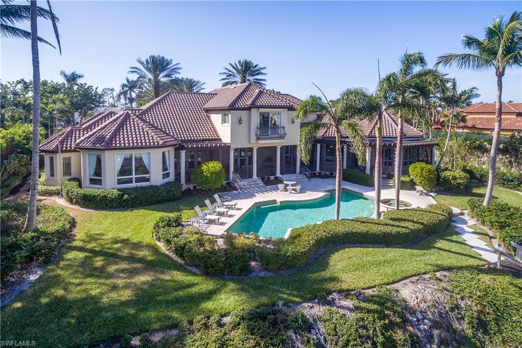 Welcome home to Port Royal, world-renowned destination of Luxury waterfront estates, on Fort Charles Dr and close to the Private Port Royal Beach Club.  Click the virtual tour link to view the cinematic video tour! This well crafted statement home provides ambiance upon entering the gates to your very own “Great Gatsby” estate!  The front door opens to a magnificent gallery hall with volume ceilings and extensive views of the water! Boasting room for family and entertaining with 6 Bedrooms in the main residence, 2 guest cabanas, movie theatre, two story library and situated on 153 ft of water frontage with direct access to the Gulf of Mexico. The Master Suite features dual bathrooms, 2 closets and a dressing room. Quality and attention to details throughout every inch of this home will be noticed.  The car enthusiast dream with rooms for several cars in the oversize garage!  Port Royal Club membership eligible and offered furnished. IMPACT Doors and WINDOWS throughout were installed.