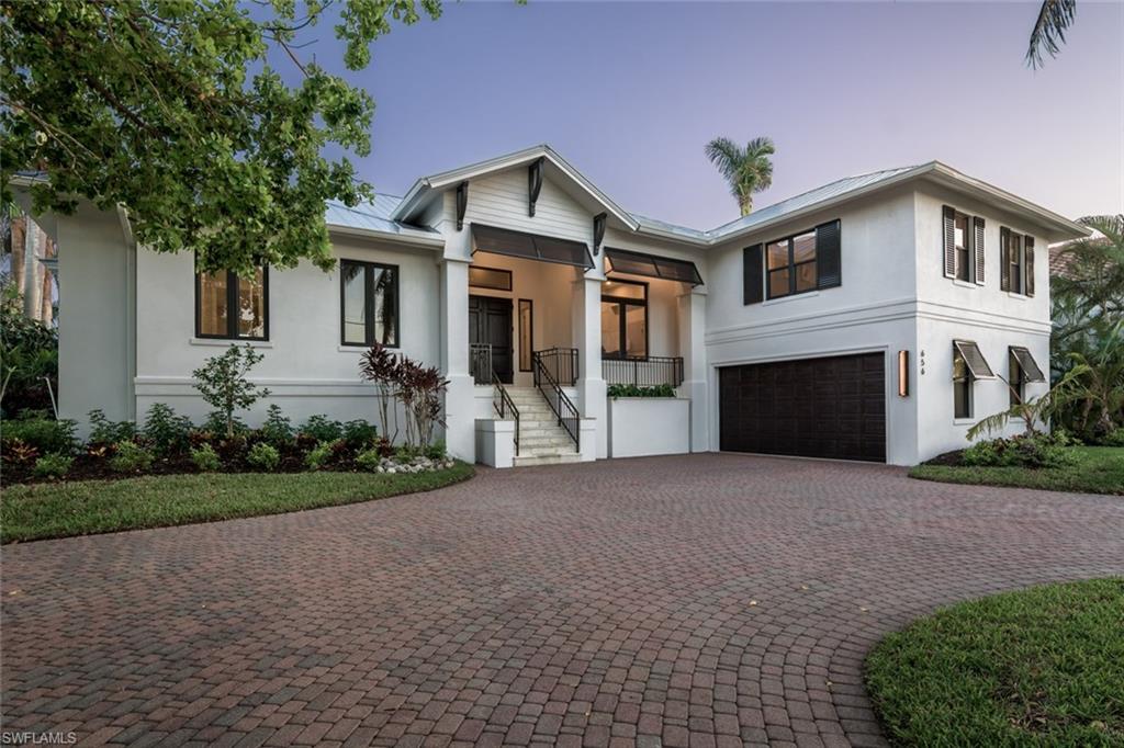Rebuilt in 2017. Above flood elevation. This waterfront cottage has been masterfully recrafted by Gulfstream Homes on a premium southern exposure lot with brand new seawall & custom Azek dock recessed to provide additional canal width.  Luxurious coastal interior features such as Legno Bastone wood floors, custom craftsman millwork, and custom cabinetry accent the living space. An efficient and expertly designed home, with hi-impact low-E glass, icynene insulation, and 3 a/c zones.  The gourmet kitchen hosts Thermador appliances and is graced by honed Mystery White marble. The pocketing sliders integrate this open floor plan with the expansive outdoor travertine living and pool deck. Includes warranties.