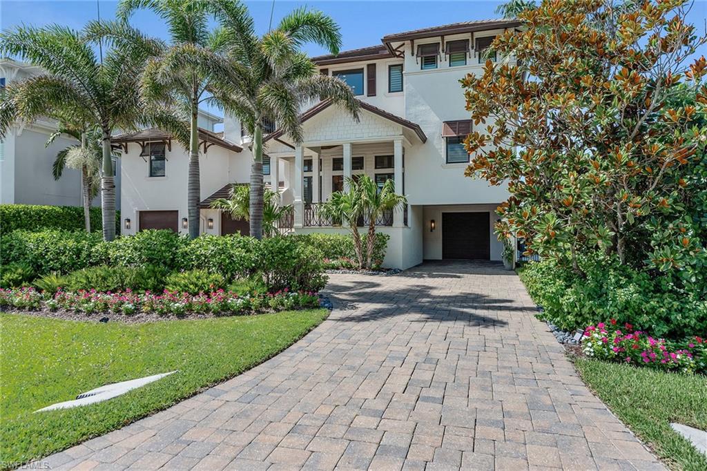 Experience Naples waterfront living in this stunning Vanderbilt Beach-area estate, a boater's paradise on a prime canal lot with gulf access. Ideal for boating enthusiasts, this property features an oversized dock with boat lift, jet ski lifts and a spacious home with 15-foot main floor elevation and an open floor plan. This home is designed for luxury living with private elevator, spacious three-car garage, exquisite craftsmanship, finishes, Wolf and Sub-Zero appliances, and open balconies blending indoor and outdoor living seamlessly. Relax by the waterfront saltwater pool, unwind on the lanai and view spectacular sunsets from the spacious dock. With top-tier hurricane-resistant features and advanced security systems, this home with desired southern exposure has a history of resilience and peace of mind. Lower level can be used for home theater, fitness or golf simulator. Just moments from Naples beautiful Vanderbilt Beach, The Ritz-Carlton, and exclusive shopping and restaurants of Mercato and only a short drive to downtown Naples. This residence epitomizes the best of luxury coastal living, complete with breathtaking canal views and seamless water access.