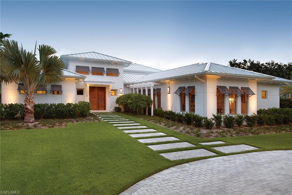 One of only 5 lots that front on Palm Circle W., going through to 3rd St. – MHK Architecture, built by Waterside Builders and brought to perfection by professional interior designer. This home was featured in Home and Design Magazine exemplifying Coastal Modernism. The meticulous attention to detail is evident & the large parcel allows for spacious indoor & outdoor living areas with 16-foot ceilings in the living room with clerestory windows, a tumbled onyx fireplace, an open floor plan with the adjoining dining room and U shaped kitchen plus a large butler’s pantry/bar area. French Oak floors, Andersen windows, high-end appliances, quartz countertops are just a few of the features. 1st floor Master bedroom, 2 additional 1st-floor en-suite guest bedrooms (one is currently used as a den) with 2 guest bedrooms upstairs with loft area & sunset balcony. An expansive outdoor area with saltwater pool & spa, summer kitchen, outdoor fireplace, pool bath & travertine deck. Located just 3 blocks to the beach and close to 5th Ave, this tropical setting blends harmoniously with nature, creating a livable and relaxed environment.