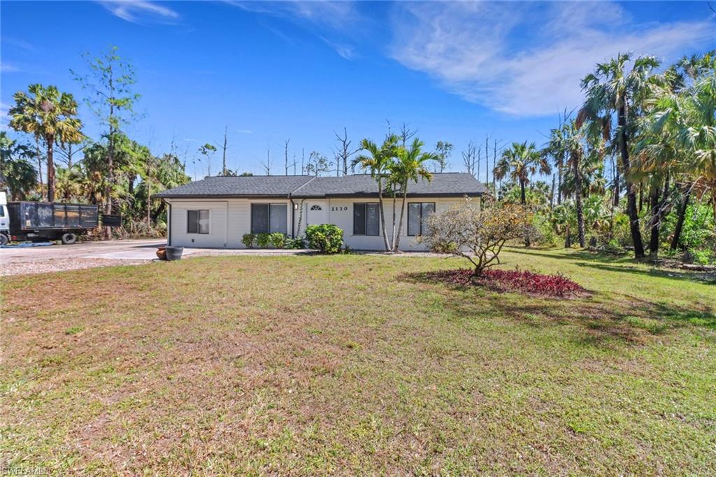 One or more photo(s) has been virtually staged, AI generated or rendered.  Exceptional location! Situated on Wilson Blvd just north of the upcoming Vanderbilt Beach Road extension, this beautifully updated 4-bedroom home sits on 2.27 private acres and offers space, comfort, and future growth potential. The home features renovated kitchen and bathrooms with quartz countertops, updated fixtures, new appliances, and numerous additional upgrades throughout. With two A/C units, including one replaced this year, and an oversized lanai ideal for entertaining and outdoor living, this property truly stands out. Now offered at an improved price — don’t miss your chance to own this exceptional property!