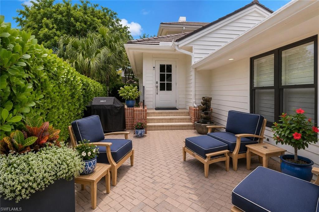 Ideally positioned just moments from the Gulf of Mexico and a short stroll to Venetian Village, this rare end-unit villa in the highly sought-after Villas of Park Shore offers the perfect blend of privacy, comfort, and effortless Naples living. Nestled within an intimate 50-residence community surrounded by multi-million-dollar homes, this beautifully maintained 3-bedroom, 2.5-bath residence lives like a single-family home while providing the convenience of low-maintenance villa ownership. Filled with natural light from soaring ceilings, expansive windows, and its desirable end-unit location, the open-concept floor plan features tile and bamboo flooring throughout, spacious living and dining areas, and seamless indoor-outdoor living. The updated kitchen is appointed with quartz countertops, premium appliances, and a striking Bianca farmhouse stainless steel sink, while impact-rated sliders open to a screened lanai ideal for relaxing or entertaining. A newly added private courtyard patio and outdoor shower enhance the home's coastal appeal, while a newly installed hurricane-rated roof provides valuable peace of mind. The first-floor primary suite offers a private retreat with a beautifully redesigned bath featuring dual vanities, a frameless glass shower, and a custom closet system. Upstairs, two generously sized guest bedrooms provide comfort and privacy for family and visitors. Residents enjoy a resort-style pool, clubhouse, fitness center, tennis courts, and pickleball. For a nominal annual fee, owners may also join the Park Shore Beach Association, offering private beach access, parking, scenic walking paths, and barbecue areas along one of Naples' most desirable stretches of coastline. A rare opportunity to enjoy the Park Shore lifestyle with beaches, waterfront dining, shopping, and everyday conveniences just moments away.