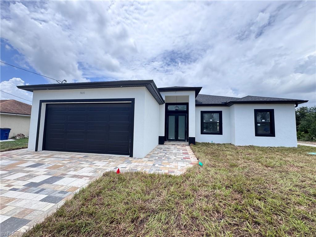 Welcome to this beautifully crafted new construction home located in one of Lehigh Acres' fastest-growing areas. Offering 3 spacious bedrooms, a flexible den ideal for a home office or guest space, and 2.5 well-appointed bathrooms, this residence combines modern design with everyday functionality.

The bright and open floor plan creates a seamless flow between the living, dining, and kitchen areas, making it perfect for entertaining and family gatherings. The stylish kitchen features quality cabinetry, granite countertops, and plenty of workspace for cooking and hosting. Elegant tile flooring extends throughout the home, providing both durability and a clean, contemporary look. The bathrooms are thoughtfully designed with floor-to-ceiling tiled showers and modern finishes that enhance the home's overall appeal. Enjoy Florida living from the covered lanai, offering the perfect setting for outdoor relaxation. The attractive paver driveway adds curb appeal and complements the home's modern exterior design. Conveniently situated near major roadways, shopping, dining, schools, and everyday amenities, this property delivers the ideal combination of comfort, quality, and location. A wonderful opportunity to own a move-in-ready home in a thriving community.