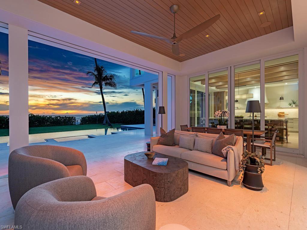 This Gulf-front masterpiece offers an unparalleled blend of location, luxury, and resort-style living. Elevated above FEMA height standards, the home has experienced no water intrusion in living areas during recent weather events. The residence combines historic charm with sophisticated elegance. Originally built in 1886, the home underwent an extensive three-year renovation and reconstruction, completed in 2024 with Kukk Architecture. Now practically new, the residence preserves its heritage, grandfathered footprint, and distinctive character while offering modern luxury throughout. The 6,100-square-foot, fully air-conditioned living space maximizes its premier beachfront setting. The well-designed layout offers five spacious bedrooms, five full and two half baths, a private study, and a flexible sixth bedroom. Sweeping Gulf views provide a stunning backdrop. The gourmet kitchen boasts dual Cristallo quartzite islands, top-tier appliances, custom cabinetry, and a service kitchen. Additional features include a private gated entry, two fireplaces, elevator, whole-house generator, automated screens/shutters, water filtration, and ultra-efficient air conditioning. Perfectly positioned on the Gulf, just moments from the dining and boutique shopping of Third Street South and Fifth Avenue South. A rare opportunity in the heart of Old Naples.