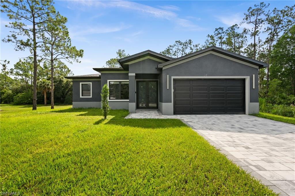 Exceptional newer construction available for annual rent in Lehigh Acres, with cable, internet, and lawn care included in the monthly rent. This beautifully maintained 3-bedroom, 2-bath home offers more than 1,700 square feet of living space with an open layout, abundant natural light, tile flooring throughout, and tray ceilings with crown molding in the main living areas. The kitchen serves as the centerpiece of the home, featuring a striking quartz waterfall island, pendant lighting, generous cabinet space, and plenty of room for cooking and entertaining. The spacious primary suite includes two walk-in closets and a well-appointed en-suite bathroom with dual vanities, a soaking tub, and a large walk-in shower with elegant tile finishes. The open lanai overlooks a peaceful backyard with plenty of room to enjoy the outdoors, whether you're relaxing with a morning coffee or unwinding at the end of the day. Additional features include impact-resistant windows, French door entry, designer lighting fixtures, 2-car garage and quality finishes throughout. Refrigerator will be installed prior to move-in. Rental application link: https://apply.link/N96UnGo.
