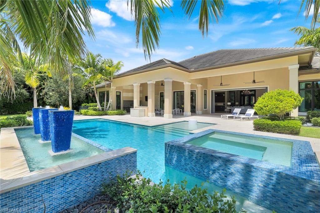 Unmatched QUALITY and attention to DETAIL!  This stunning McGarvey Custom Homes residence with interior design by Clive Daniels will appeal to the most discerning buyer. Located in Pine Ridge Estates, this luxury home offers nearly 4,700 square feet of sophisticated living space on a very private one-acre lot secured by a private gated entrance.  From the moment you step inside, you’ll experience the WOW factor from the craftsmanship, attention to detail, timeless design, and expansive view of the outdoor living space.  The open-concept great room with fireplace flows seamlessly into a chef’s kitchen with top-of-the-line Wolf and Sub Zero appliances, beautiful cabinetry, large island, wine bar, and breakfast nook leading out to the lanai. You’ll find four spacious bedrooms, each with its own ensuite bath and walk-in closet, plus a large den with french doors and elegant finishes throughout. The primary suite is truly a retreat, complete with a cozy sitting area with bay windows and a spa-inspired bath.  One of the many highlights of this home is the indoor-outdoor living experience. The expansive lanai of nearly 700sf features a large covered sitting area with a fireplace, outdoor kitchen, retractable screens, and a resort-style heated saltwater pool and spa surrounded by lush landscaping—offering both privacy and the perfect backdrop for entertaining or just unwinding.  The Crestron Home Intelligent Automation system allows you to control the entire home from anywhere - this along with impact glass throughout and a whole house generator give you peace of mind year-round.  The Pine Ridge Estates neighborhood is one of the most popular in Naples for its rural aesthetic, abundant privacy, large lot sizes, and ideal location. Its close proximity to the beach, fine dining, shopping and entertainment provide the perfect blend of serenity and an active lifestyle .  This home is a short stroll to the upscale and vibrant Mercato, a Naples go-to destination, as well as minutes from Waterside Shops, Vanderbilt Beach, and 5th Avenue downtown.  Come experience the best of what Naples has to offer in this stunning home!