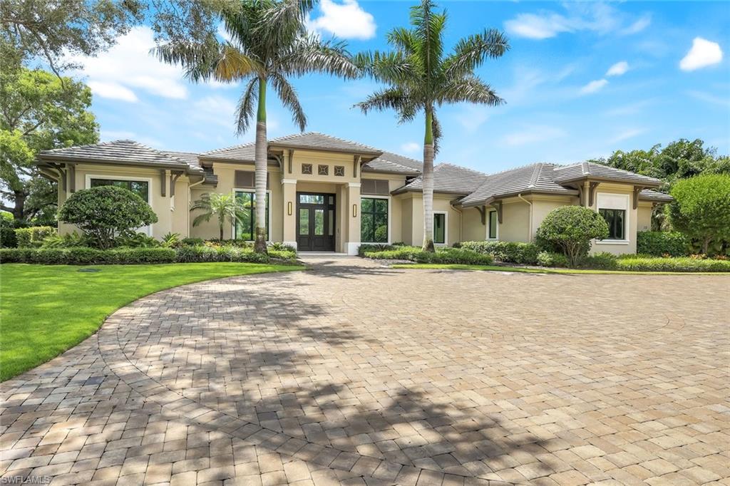 Unmatched QUALITY and attention to DETAIL!  This stunning McGarvey Custom Homes residence with interior design by Clive Daniels will appeal to the most discerning buyer. Located in Pine Ridge Estates, this luxury home offers nearly 4,700 square feet of sophisticated living space on a very private one-acre lot secured by a private gated entrance.  From the moment you step inside, you’ll experience the WOW factor from the craftsmanship, attention to detail, timeless design, and expansive view of the outdoor living space.  The open-concept great room with fireplace flows seamlessly into a chef’s kitchen with top-of-the-line Wolf and Sub Zero appliances, beautiful cabinetry, large island, wine bar, and breakfast nook leading out to the lanai. You’ll find four spacious bedrooms, each with its own ensuite bath and walk-in closet, plus a large den with french doors and elegant finishes throughout. The primary suite is truly a retreat, complete with a cozy sitting area with bay windows and a spa-inspired bath.  One of the many highlights of this home is the indoor-outdoor living experience. The expansive lanai of nearly 700sf features a large covered sitting area with a fireplace, outdoor kitchen, retractable screens, and a resort-style heated saltwater pool and spa surrounded by lush landscaping—offering both privacy and the perfect backdrop for entertaining or just unwinding.  The Crestron Home Intelligent Automation system allows you to control the entire home from anywhere - this along with impact glass throughout and a whole house generator give you peace of mind year-round.  The Pine Ridge Estates neighborhood is one of the most popular in Naples for its rural aesthetic, abundant privacy, large lot sizes, and ideal location. Its close proximity to the beach, fine dining, shopping and entertainment provide the perfect blend of serenity and an active lifestyle .  This home is a short stroll to the upscale and vibrant Mercato, a Naples go-to destination, as well as minutes from Waterside Shops, Vanderbilt Beach, and 5th Avenue downtown.  Come experience the best of what Naples has to offer in this stunning home!