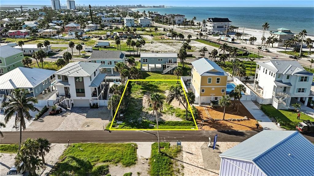 This oversized lot delivers it all—space, location, and endless opportunity! One of the largest available parcels in the area at an unbeatable price, offering the perfect canvas to design your dream island escape in the heart of Fort Myers Beach. Mid Island Drive is already home to six newly built residences, making it one of the most desirable streets on the island. Imagine your custom home here with a South Facing Pool to capture all-day sunshine and stunning sunsets. BUILDER INTRODUCTIONS AVAILABLE to help you bring your vision to life with ease. Tucked away on peaceful Mid Island Drive, yet just moments from Connecticut Street Beach Access, this location gives you the best of both worlds—seclusion when you want it and excitement when you don’t. Start your mornings with the salty Gulf breeze and strolls along the shoreline, spend your afternoons basking in the Florida sun by your private pool, and enjoy evenings filled with unmatched sunsets and vibrant island dining. With Margaritaville and the revitalized downtown scene to the north, and Santini Plaza’s boutiques and restaurants to the south, every adventure is at your doorstep. A lot this size in this prime location at this price is a rare find. Whether you’re envisioning a vacation retreat or a year-round coastal haven, don’t miss your chance to secure your personal slice of paradise.