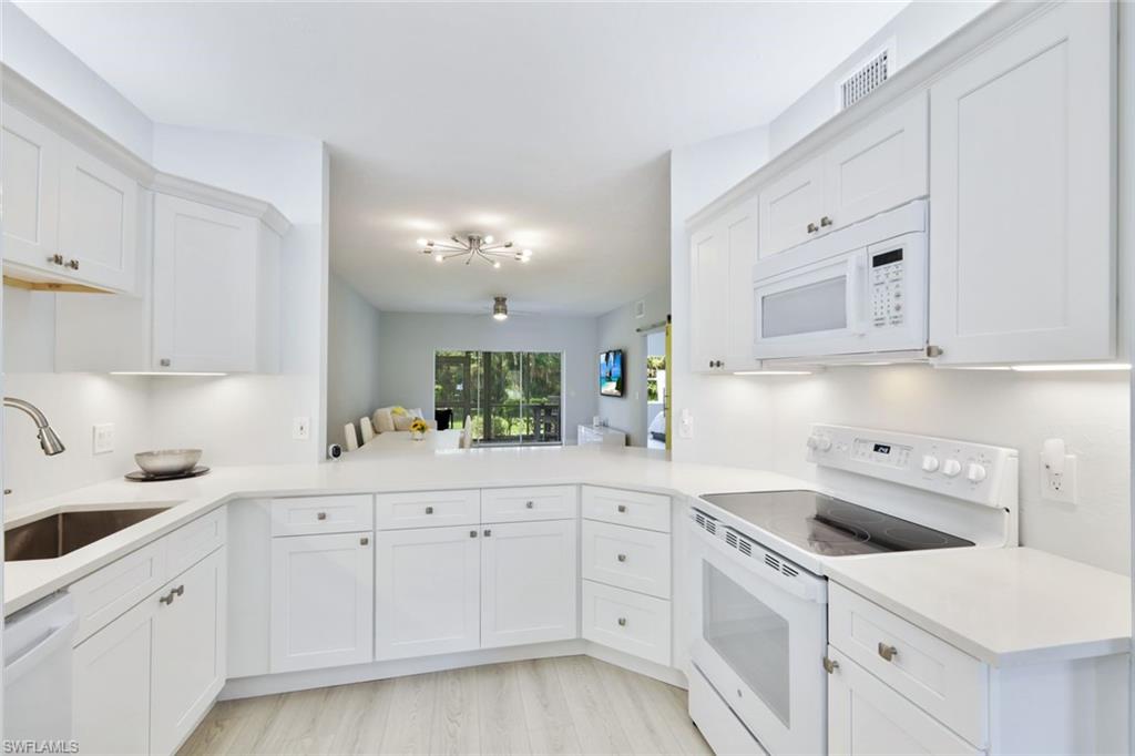 Paradise awaits! Tucked in a quiet corner of Cape Coral, this hidden GEM is just minutes to Tarpon Marina, which hosts premier waterside shopping and dining, and provides easy boating access to Fort Myers beach, Sanibel/Captiva Islands, Cayo Costa State Park, Pine Island and all the beautiful waterways. This beautiful first floor residence is a small community and provides covered parking, large pool and a peaceful setting with tropical views. Enjoy the great outdoors with the bike trail at your doorstep, nature preserve, Rotary Park and Glover Bight Parks nearby. Open concept and spacious floor plan, this newly remodeled home offers a beautiful white kitchen, all new appliances, an oversized bar counter for entertaining. The home boasts luxury vinyl tile throughout, neutral colors, and a fully enclosed walkout lanai overlooking a green landscape. Full condo radon mitigation system installed for healthy indoor air quality! Modern flairs abound with two vibrant sliding barn doors. Bedrooms appointed with RH furniture and organic Avocado Green mattresses, bathrooms refinished with new vanities, modern lighting w/backlit LED, main bathroom walk in shower! MoveInReady! Prime location!