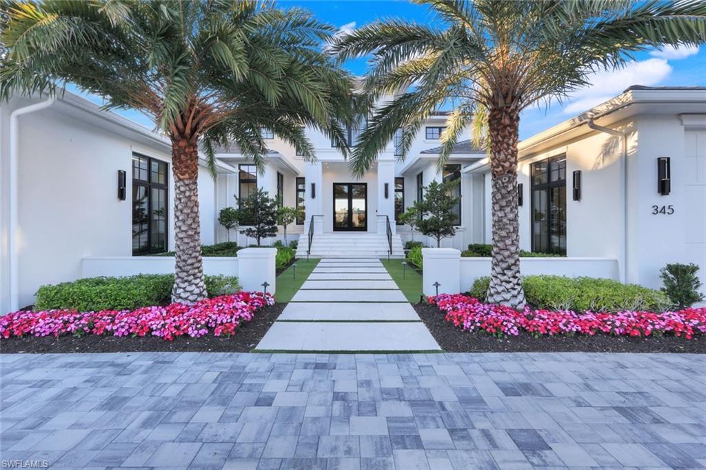 The Good Life. On one of the most beautiful Lanes in Naples, with dazzling direct waterfront views, your glorious next chapter begins. Amidst a landscape of indistinguishable new houses, this exceptional custom designed residence features the finest finishes, superior materials and quality workmanship caringly brought to life with warmth and agelessness. Penned by noted Architect, Lars Young and crafted by the prominent Builder, D. Roth Construction, it is a truly elegant yet extremely comfortable home. Positioned perfectly on Compass Cove, you will experience incomparable sunsets and the singular pleasure of gulf access from your own backyard. The intelligent plan throughout this property will excite the most discerning boat enthusiast, thrill the seasoned gourmand and please those who simply love to entertain, escape and relax. An enormous Great room with European white oak flooring complements the designer furnishings, exquisite cabinetry and stunning stone work.  The adjacent lanai and outdoor kitchen serve as an extraordinary large living/dining space leading to a gorgeous pool and spa with an infinity edge basin. Along with all the upscale brand appliances befitting a property of this level, you will be delighted to find an outdoor Pizza oven, a LG Steamer in your California Closet and mood-enhancing fireplaces. A cleverly placed expansive butler’s pantry houses additional storage and luxe equipment. The primary suite includes two walk-in closets, two water closets with Neorests and an enchanting separate study. Your guests can select from a ground floor private casita or from two spacious upstairs ensuite bedrooms. The exclusive Moorings beach park and Venetian Village restaurants and boutiques are just minutes away,