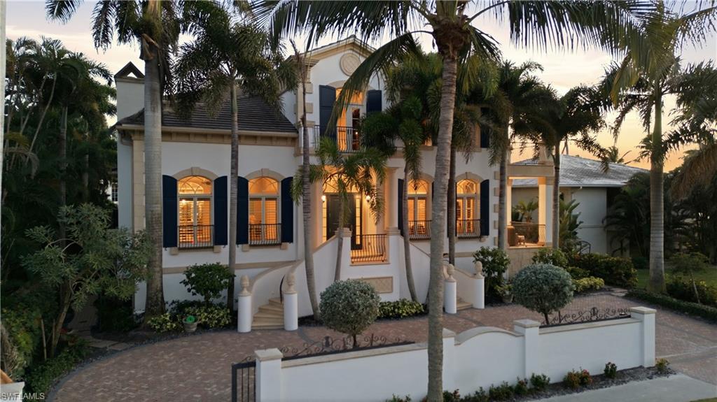 The intrinsic values living down town is where everybody wants to come. Located ONE HOME IN from the beach and the vibrant lifestyle of 5th Avenue South, with culture, parks, theaters, finest restaurants, this exceptional residence embodies the very best of Old Naples living. Directly across the street beach block lot JUST SOLD in May 2026 for $37,000,000, (rumor has it….one mansion home will eventually be built). 

This spectacular home site 85’ X150’ is  high and dry at 12’ elevation NEVER A DROP OF WATER in living area..impressive curb appeal and unique architecture with twin stair case to grand entrance. Entire two story home is concrete block built by award winning BCB Builders. Spectacular royal palm trees boarder the entire property ,paver walkways, and lush tropical landscaping  85' x 150' lot, while the rear alley leads to a 3-car garage and a private elevator servicing all levels.

The fireplace living room flows seamlessly into an 800-bottle climate-controlled wine room, creating the perfect setting for intimate gatherings or memorable evenings with friends and family. Sunlight fills the inviting family room, where French doors open to a spacious open-air terrace with views of the Gulf.

The chef’s NEW CUSTOM KITCHEN is a culinary dream—equipped with a Viking gas range, expansive center island, and premium finishes. Nearby, a dramatic round dining room with rotunda ceiling comfortably seats ten. 

On the first level, the luxurious primary suite features French doors leading to a private terrace overlooking the pool and gardens—a serene retreat. The second level offers a speak easy lounge, a media/family room that flows easily into the adjacent office/library. French doors open to a magnificent terrace with sweeping Gulf views and unforgettable sunset skies. Four large guest suites, each with a private bath, provide comfort and privacy for all.

An exterior spiral staircase leads to the rooftop deck, complete with built-in seating—an extraordinary vantage point to enjoy Naples’ moody skies and breathtaking sunsets. Outdoors, soak up the sun by the resort-style pool, unwind in the spa, or host gatherings in spaces designed for effortless entertaining. This home is ideal for philanthropic events, elegant soirées, and memorable family celebrations.

Living on 5th Avenue South means you are footsteps from 41 restaurants, theaters, art galleries, Cambier Park, the tennis center, boutique shopping, and the newly opened Four Seasons nearby. Explore Tin City, charter a fishing boat, or sail into the sunset—the lifestyle here is vibrant, active, and endlessly inspiring.
