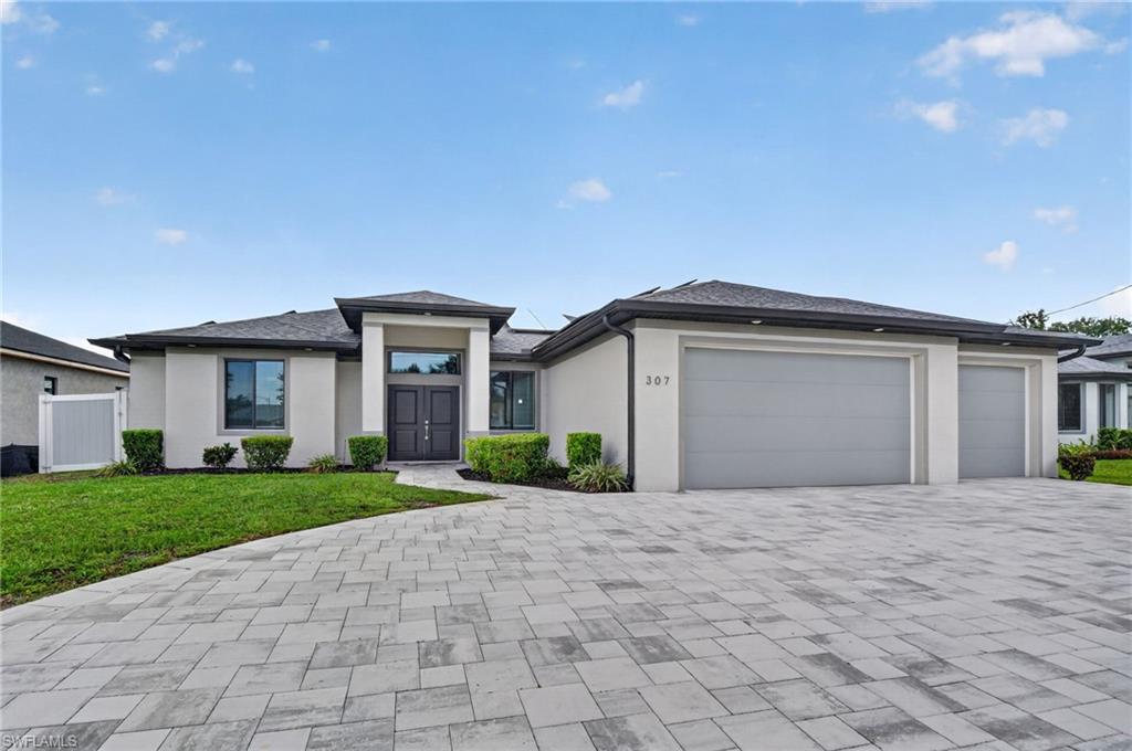 STUNNING NEWER CONSTRUCTION W/OWNER/BUILDER UPGRADES ($250,000+/-) 4 BEDROOM, DEN, 2 BATH, POOL-SPA, 3 CAR GARAGE, SOLAR-POWERED HOME (WHAT, NO ELECTRIC BILL, HOW COOL IS THAT!)($65,000 ALL PAID)! The home is in the "X" ZONE, no flooding or Flood Insurance required or needed. The Cape Coral Life-style: BOATING-FISHING-BEACHES & SUNSHINE YEAR ROUND. Tucked into the highly sought-after SOUTHERN PART OF THE CAPE. BIG OPEN FLOOR PLAN with 14' VOLUME AND TRAYED CEILINGS, all PORCELAIN "WOOD PLANK" CUSTOM TILES through the entire home for complete "ease of maintenance". True "CHEFS" Kitchen  with all "42" MAPLE WOOD CABINETS, LEVEL 5 GRANITE TOPS, HIGH END WHIRLPOOL STAINLESS STEEL APPLIANCES, PANTRY and  14' EAT-AT-BAR for those family kitchen FUN FOOD times & gatherings.  ALL DOORS, WINDOWS AND SLIDERS ARE HIGH "IMPACT" STORM RESISTANT FOR TOTAL STORM & HURRICANE PROTECTION. Home has great CURB APPEAL, from the beautiful curved paver driveway and walkway to the homes walk-up entry. The home close to: a-rated schools, hospitals, churches, restaurants and the best of southwest Florida's entertainment is just minutes from downtown, Tarpon Point Marina, and Cape Harbour, where waterfront dining, shopping, and entertainment are always within easy reach. From the moment you arrive, the extended U-shaped driveway and double door entry set the tone for what’s inside. MASTER BEDROOM , has HIS & HERS walk-in closet, dual granite sinks, soaking tub and all glass & tile walk-in shower. This home has been carefully upgraded for both sophistication and everyday ease. Step out back and you’ll find your own private playground with a SOUTH BEACH VIBE - a heated "saltwater" pool and spa with a "Hayward System" you can control right from your phone, all overlooking a SPECTACULAR wide 90-foot canal VIEW. With a concrete dock already in place and no flood zone designation, you get the waterfront lifestyle without the added insurance cost. The vinyl privacy fence adds an extra layer of comfort, making the outdoor space feel like your own. Even better, the solar system covers 100% of the home’s energy usage, including heating the pool. A versatile den provides the flexibility for a home office, guest space, or additional bedroom. All kitchen appliances all less than five years old. The home is being offered optional furnished. Meticulously maintained and move-in ready, this home truly stands out for its care, efficiency, and location. HOME COMES WITH A ONE YEAR "HOME WARRANTY" FOR TOTAL BUYER COMFORT!