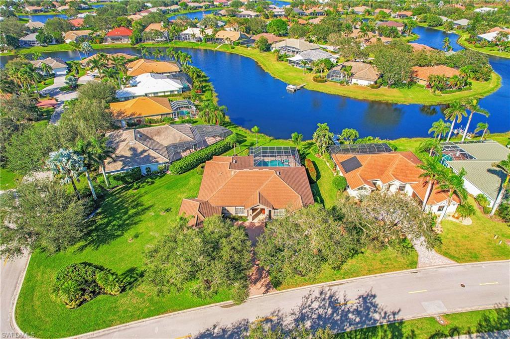 Handsomely furnished 3BR +den home with the expansive western lake views everyone dreams of in Longshore Lake. We all want to live outdoors in SWFL and this home has what you need...outdoor kitchen with tiled backsplash, built in grill, granite countertops, sink, fridge and separate counter/bar area with additional seating. The fossil stone paver deck was recently replaced and presides over a massive patio area with raised spa and drip edge into the pool.  The pie shaped lot gives privacy abound and lots of extra green space. New roof 2019. The kitchen has been completely remodeled as well in the past few years with all the bells and whistles: two toned custom cabinets, slate black appliances, inset cooktop, raised dishwasher, farmhouse sink, quartz counters, etc. High ceilings throughout and attractive tray ceilings in living room and primary bedroom.  Primary bath has been recently updated with new vanities, tiled inlay, glass shower door, mirrors and hardware. Tons of storage throughout including in the oversized 2.5 car garage. The amenities at Longshore Lake include 9 clay tennis courts, fitness center, full restaurant/bar and full time activities director.