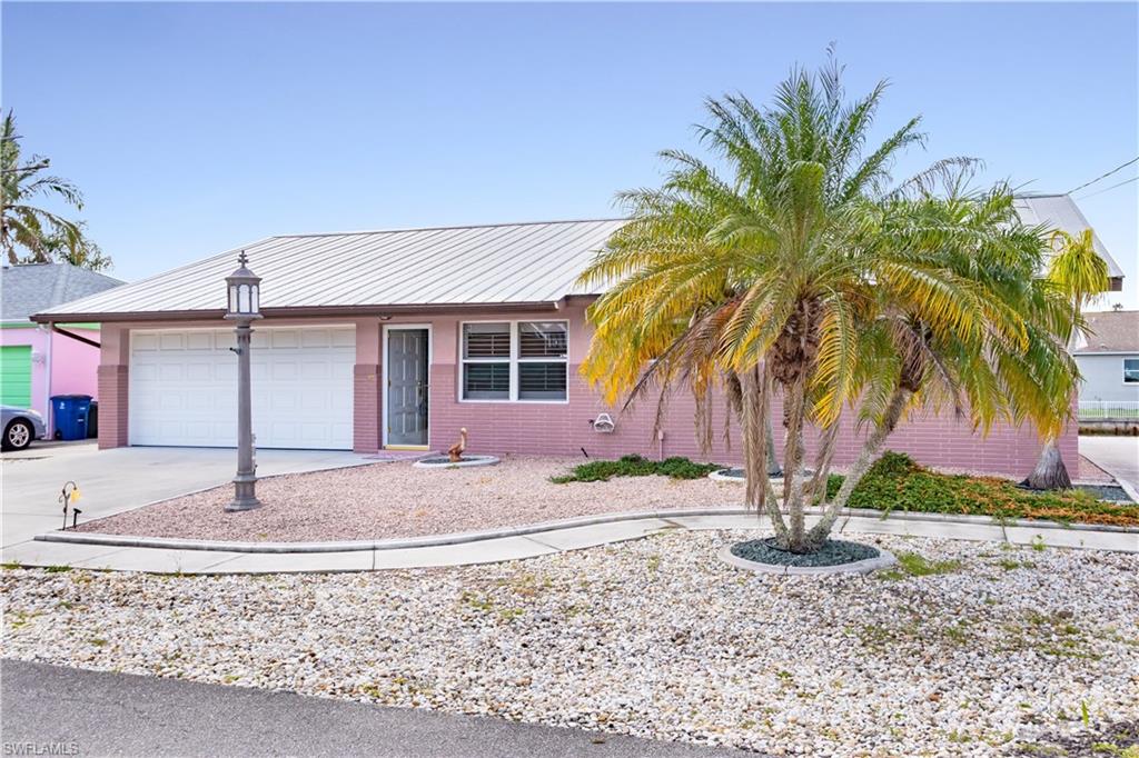 WATERFRONT **DIRECT ACCESS** ISLAND LIVING!   Imagine yourself driving onto this small island oasis…turning onto the cul-de-sac street with waterfront homes on both sides…walking into this FURNISHED/TURNKEY home… and you are home!  BRAND NEW SEAWALL installed this year!  Two HUGE sunrooms/enclosed lanai areas…one located right off the master bedroom.  Stunning walls of sliders with gorgeous VIEWS OF THE WATER make this home light and bright!  Easy maintenance required on this home with xeriscape landscaping—no grass mowing here. METAL ROOF!  Updated Kitchen with; lots of storage, glass cabinet doors, HUGE breakfast bar, sliding window for outside serving, appliance garage, pullout shelving, and a BEAUTIFUL VIEW!  No worries about parking; two-car garage and TWO DRIVEWAYS!  Matlacha offers destination restaurants and shopping…and QUICK BOATING ACCESS to the Gulf of Mexico, beaches, and surrounding islands such as Cayo Costa, Cabbage Key, Sanibel, Boca Grand and more...not to mention...this area offers some of the best fishing to be found anywhere in the world! Fort Myers International airport is only about 30 miles away and Punta Gorda Airport only about 24 miles. Call today~