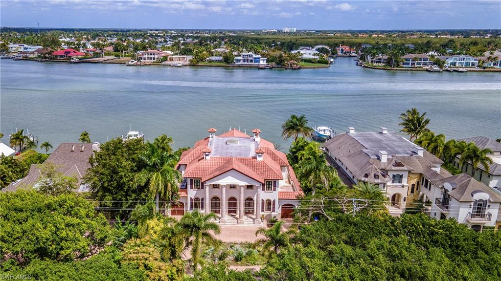 Impeccable Naples Bay views from this authentic Tuscan designed home featuring marble columns and floors throughout. Built in 2001 this home has been beautifully maintained yet is perfect for updating or remodel. Just a few features include home theatre, large formal dining room, wood lined library/study, large master suite with custom designed walk-in closet, oversized lot and much more!