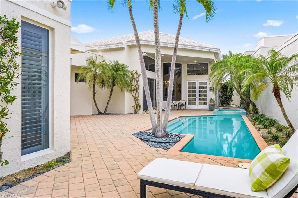 Experience the absolute pinnacle of coastal living at 7897 Cocobay Dr, a sophisticated sanctuary nestled within the prestigious Pelican Bay. This meticulously maintained  home offers the main home and a separate guest quarters connected under the same roof line.   This provides the perfect floor plan for both quiet relaxation and effortless entertaining. The magic of this location cannot be overstated. Situated in the highly sought-after CocoBay enclave, you are just a short, stroll across the boulevard to the beach tram station and the scenic board walk. Whether you’re starting your morning with a brisk walk along the nature paths or heading out for a sunset dinner, the best of Naples is quite literally at your doorstep. As part of Pelican Bay’s 570-acre master-planned community, the lifestyle extends to private beach pavilions with dining and beach-service amenities, scenic walking trails through mangroves, world-class shopping and dining nearby at Waterside Shops and Mercato all just minutes away. Whether you’re looking for a seasonal retreat, full-time coastal home, or an entertainer’s dream home, this home delivers a lifestyle of luxury, comfort and unsurpassed natural beauty.