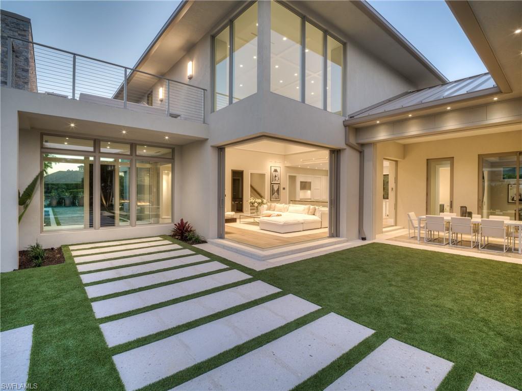 Certificate of Occupancy has been issued, and this home is now ready for its lucky owner! This HLevel designed home, built by custom home builder Dan Klein Construction Inc, is the perfect example of contemporary meets classic.  Designed for luxury living AND entertaining, every detail has been implemented to make your home more functional and enjoyable. Extra space in the 3 car garage, AQUALatch leak detection system, 1000 gallon propane tank, 21 foot+ ceilings throughout open concept kitchen/great room, 90° sliders provide the ultimate in outdoor-indoor living space. TWO islands in the kitchen, flex space can be used as another bedroom/theater/game room/studio, framed for an elevator, Anderson impact rated windows, WinDoor impact rated sliders and doors, Thermador appliances in kitchen, Lutron remote switching for entire first level, exquisite outdoor living space, landscape lighting, linear drains in showers, linear a/c vents, indoor & outdoor fireplaces, huge laundry/pantry/mud room, sun deck overlooking the incredible outdoor living space, 2nd master upstairs with highly coveted SW views from the balcony, standing seam metal roof, and so much more!