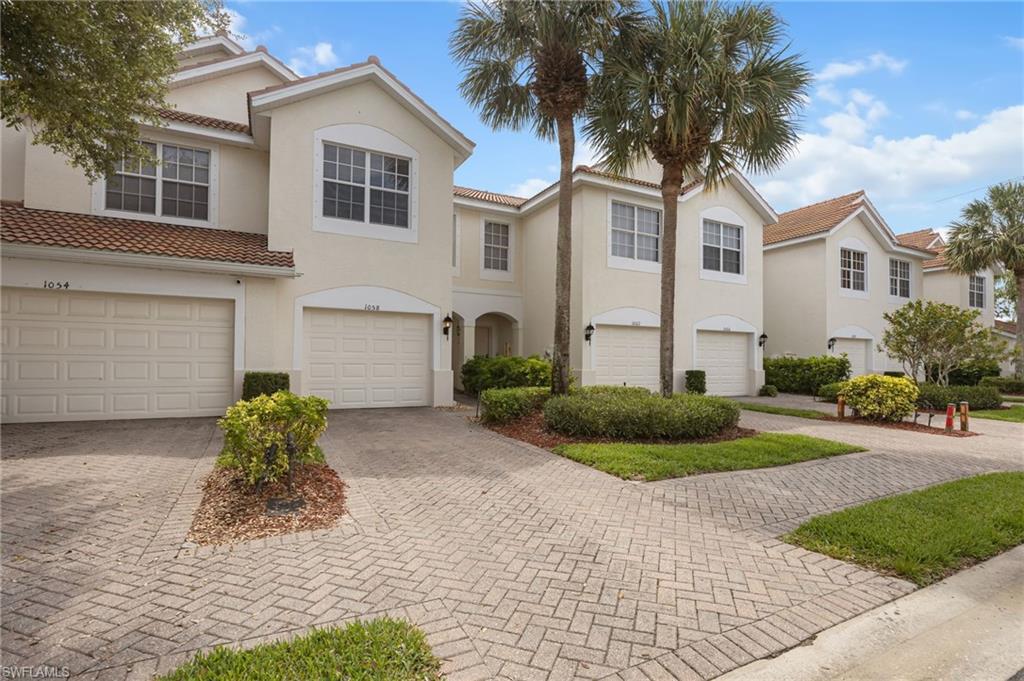 Freshly updated and move-in ready, this three-bedroom, two-and-a-half-bath townhouse in Stratford Place offers a stylish blend of comfort, functionality and modern finishes in a highly convenient Naples location just off Pine Ridge Road. Inside, the home feels bright and cohesive with a fresh repaint and luxury vinyl flooring carried throughout the entire property, creating a clean, low-maintenance look from the main living areas to the upstairs bedrooms. The kitchen serves as the centerpiece of the home, featuring quartz countertops, a spacious island with added storage, stainless steel appliances, generous cabinetry, and a large stainless sink with water filtration. The main-level half bath has been completely remodeled and elevated with marble flooring, adding a refined touch for guests. The living area opens to peaceful lake views and a screened lanai finished with new modern patio tile, creating an inviting outdoor space framed by mature landscaping. Upstairs, the primary suite enjoys relaxing views of the lake and greenery, while two additional bedrooms provide comfortable space for family, guests or a home office. A newly finished epoxy garage floor and front-loading GE washer and dryer add even more value to this thoughtfully improved Naples townhouse.