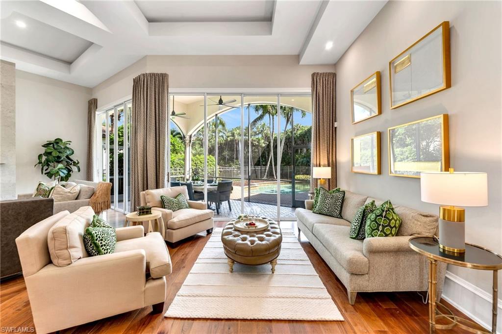 Welcome to this masterfully reimagined residence, where every detail reflects exceptional craftsmanship and architectural design. Upon entering, you’ll be captivated by the soaring, illuminated, raised ceiling that creates an open concept in the main living areas – an extraordinary feature that truly distinguishes this home. The thoughtful renovation, with the removal of walls and an arched ceiling, has opened up the space, creating a seamless flow between the living and family rooms. Modern touches like squared, raised archways, architectural new light fixtures, LED lighting, and Emtek hardware throughout, enhance the residence’s contemporary elegance.

The gourmet kitchen is a chef’s dream, featuring high-end appliances, including Wolf, 
Sub-Zero, Bosch, dual refrigerator drawers, and an icemaker. Discerning tastes will appreciate the leathered Taj Mahal quartzite countertops, classic tile backsplash, custom cabinetry, polished nickel hardware, Kohler fixtures and granite sink.  Around the corner, a bar complements the space with custom wine cabinet, wine refrigerator, and Taj Mahal counter…all so perfect for hosting gatherings and entertaining guests.

In the family room, the stunning floor-to-ceiling, limestone-tiled fireplace and TV wall with art niche, set a dramatic backdrop. The open concept interior architecture allows for so many of the rooms to enjoy the private, water, fountain, and cascading waterfall views.

The primary bath is a sanctuary of relaxation, with leathered marble countertops, Kohler fixtures in polished nickel, mirrors encased in custom woodwork, and a six-foot Kohler "Le Rêve" tub. A Baccarat French crystal chandelier adds a touch of opulence above the tub, making each bath a luxurious experience. Throughout the residence, attention to detail continues even into the powder bath, where thick, quartzite has been added to a custom vanity with Brizo fixtures, and guest baths have Cristallo quartzite.

Outdoor living is equally enchanting, with a large, screened dining area, freeform pool with variable-colored pool lights, and a waterfall as part of the spa. A separate sitting area under palm trees offers tranquil views of the pond, large water fountain, cascading waterfall and lit palm tree landscaping.  This home offers an unparalleled setting for ultimate relaxation and entertaining.

This elegant residence features a recently installed roof in 2020 and is fully equipped with AstroGuard hurricane protection for all openings, combining elegance and peace of mind. 

Located in the prestigious Grey Oaks Country Club, this residence provides access to a 30,000 square-foot Wellness Center, two clubhouses, three restaurants, three championship golf courses, an exceptional racquet center, bocce ball, and a resort-style pool, among other world-class amenities. Welcome to your new home!