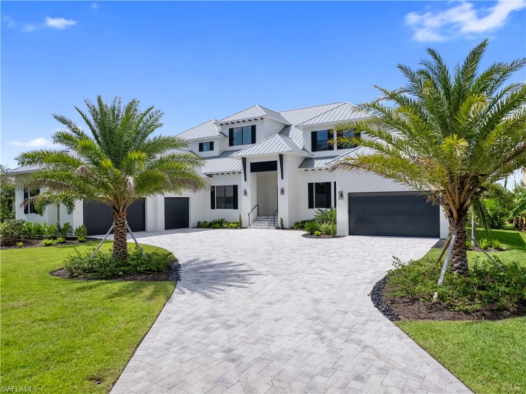 Discover Easy Luxury Living in this Brand-New PGI Built Riverfront Estate, tucked away in the exclusive Magnolia Point gated enclave. With stunning waterfront views, this spacious estate offers over 10,000 square feet & beautiful hardwood floors that flow throughout the entirety of the home. There are 6 comfortable bedroom suites, PLUS a Private VIP suite, along with 7.5 stylish bathrooms. The home offers a den/zoom room & craft room. The kitchen includes high end Thermador appliances including a wine cooler, a hidden pantry, granite countertops, and double island. The Private VIP suite of the home includes its very own 2-car garage, living room area, huge custom closet, bathroom, spacious bedroom, and a kitchen with stainless-steel appliances. The VIP suite offers endless views of the waterfront. The 2nd floor includes a spacious veranda, living area, bar, 4 spacious bedroom suites, a huge primary bedroom suite, fantastic bath and closet areas. The outdoor entertainment area includes a huge 16x45 ft pool with spa and sun shelf. The open and covered deck space is amazing. Plans for dockage and boat lift are in place and will allow for all your boating needs. Additional features include a 5-car garage and a whole-home generator for added convenience. With only 18 luxurious homes in this private enclave, you get the best of all worlds—peace, privacy, and a gorgeous waterfront lifestyle.