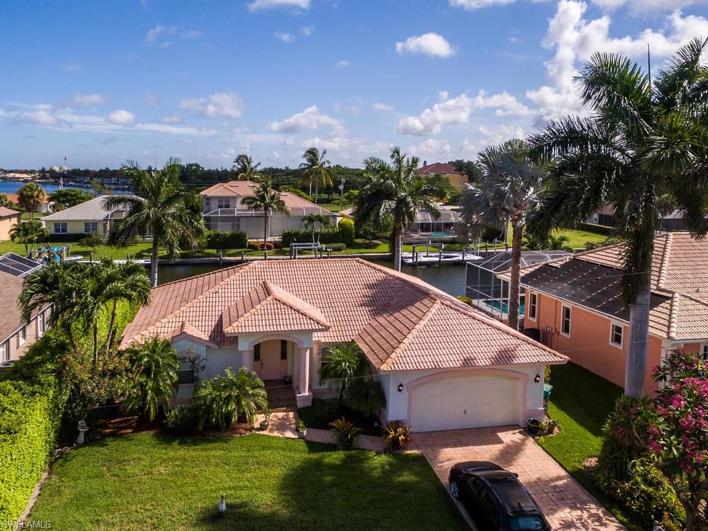 Gulf access and white beaches of Marco Island makes this home perfect for living the paradise life. Move-in ready, renovated kitchen with granite counter tops, stainless steel appliances, cathedral ceilings, tile throughout, and an open floor plan are all designed for easy living. Electric boat lift/dock for your boat. Over-sized garage offers extra storage or work/hobby area. No HOA fees. Quiet, cul-de-sac street. Great for full-time or seasonal homeowners looking to enjoy life, boating, fishing, shopping, dining, or playing at the beach. Sewer assessment is paid in full.