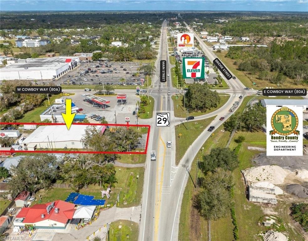 PRIME LOCATION IN BETWEEN WINN-DIXIE AND HELMS ROAD EXTENSION IN PATH OF PROGRESS! The facility consists of a 7,500 sq. ft. steel building  with a 1,050 sq. ft. addition. The building boasts a new metal roof (installed in 2023) and new acrylic finished flooring. The property site is .578 acre with 100' on State Road 29 S. Front of the building features asphalt parking area and open canopied front porch for display purposes; back of building is situated on Luckey Street, providing rear access plus the current workshop and repair area including Ted's shed. Zoning is C-3, offering many commercial uses. Property is in Hendry County, but is serviced by City water. The building is open with center offices which can be easily removed or relocated and has some loft storage.