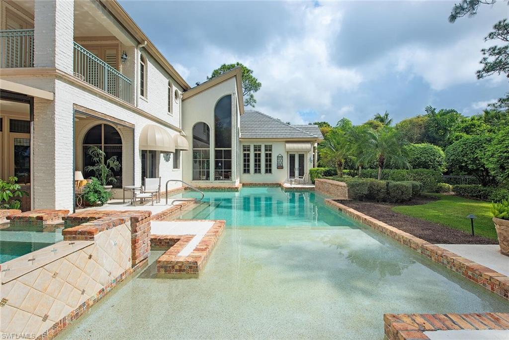 Welcome to Resort Style Living, Welcome to Grey Oaks. Just a short walk to the club, this stunning home is situated on over one-half acre with expansive, southwestern lake and golf course views of the Palm course. The character and charm of this beautiful 2 story home is felt from the moment you walk through the door.  Floor to ceiling windows in the living room, open kitchen and family room, 1st floor master, brick wine bar, large office, are just a few highlights of this special home. Large windows throughout make this home filled with natural light. Feel like you’re on vacation everyday of the year as you stroll to the club or simply relax at home enjoying your private back yard with pool and spa.Outdoor kitchen, New roof 2021. This home is not to be missed! Grey Oaks Country Club is Naples one and only private club with 54 holes of golf. In addition, the club offers exclusive amenities for all, from the newly renovated wellness center to the lagoon style pool, tennis, pickle ball, bocce, restaurants, spa... the amenities are endless.