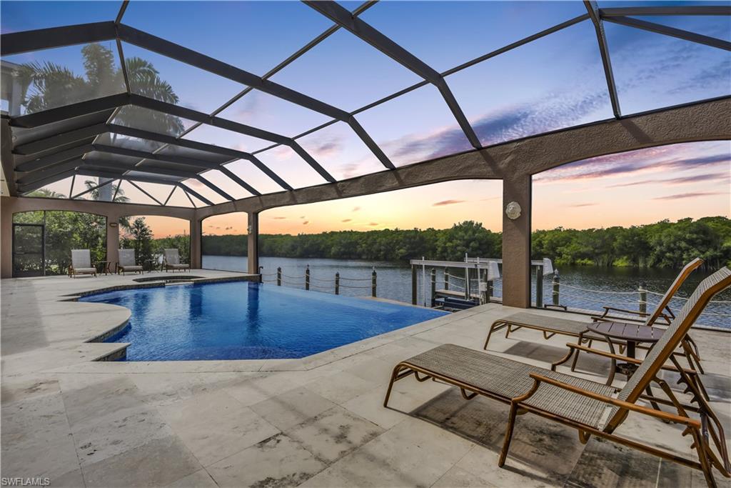 Luxury waterfront living! Custom built waterfront home w/ direct Gulf access, designed & built w/ integrity by current owner's building company- so you can be sure NOTHING has been overlooked! High-end luxury features can be found throughout this sprawling 2-story home- elevator, handmade French wood door at front entry, gorgeous marble flooring w/ custom granite inlay, wrought iron railing on staircase, gourmet kitchen w/ commercial grade KitchenAid appliances (gas range w/ griddle & custom vent, pot filler, double convection wall ovens, warming drawer, dishwasher & dish drawer, & wine cooler), fireplace, beautiful custom millwork, central vac, volume & tray ceilings, plantation shutters, high-end light fixtures & remote control fans, laundry rooms on both floors, generator(almost entire home) w/ switch, Kevlar storm protection on lanai, impact windows/doors, & more! Stunning outdoor living space offering a summer kitchen, full pool bath, infinity edge pool w/ spa, picture window screens, huge open lanai lining the boat dock w/ captain's walk & 12k lb boat lift. Wonderful coastal setting that is one of a kind- a fantastic place to relax & unwind, gather w/ family, and entertain!