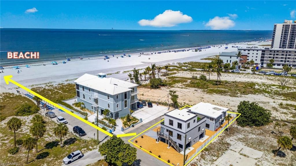 ONE LOT OFF THE GULF! GULF VIEWS INCLUDED! GULF-FRONT PRICING NOT REQUIRED…..  Some properties are valuable because of what is built on them. Others are valuable because of where they sit. This property offers both. Located just one parcel from the Gulf, this unique beachside compound places you close enough to hear the surf, feel the Gulf breeze, enjoy spectacular sunset skies, and experience the unmistakable character of Fort Myers Beach that has attracted visitors, investors, and families for generations. What makes this offering different is not any one feature. It is the combination of features that rarely come together in a single property. Four unique units. Four bedrooms. Four-and-one-half baths. Gulf views. Immediate beach access. Weekly rental flexibility. Walkability to Margaritaville Resort, restaurants, entertainment, and the growing list of attractions is helping shape the future of Fort Myers Beach. Most properties offer some of these attributes. Very few offer all of them. This offering includes both 71 Mango Street and 2401 Cottage Avenue, with the benefits of new construction at 71 Mango Street and a complete remodel at 2401 Cottage Avenue. The properties are legally structured as a condominium association and must be sold together, creating a larger and more versatile ownership opportunity than is typically available in this location. The result is a property that can serve many purposes equally well. A private beach retreat. A multigenerational family compound. An income-producing investment. A long-term hold in one of Southwest Florida's most dynamic coastal markets. Or a combination of all four. Leave the car parked. Walk to the beach. Walk to dinner. Walk to Margaritaville. Spend the afternoon on the water. Watch the sunset paint the Gulf horizon. Repeat as often as you like. That lifestyle has always been the foundation of Fort Myers Beach. What is changing is everything around it. Millions of dollars in public and private investment are reshaping the island. New development, new businesses, improved infrastructure, and renewed confidence continue to accelerate the transformation. Buyers who understand coastal real estate recognize that opportunities are often greatest when a destination is evolving, not after the transformation is complete. Fort Myers Beach has always been special. The difference today is that many believe its best years may still be ahead. Properties this close to the Gulf have always been desirable. Properties this close to the Gulf with four separate units, weekly rental flexibility, new construction, Gulf views, and this level of accessibility are difficult to acquire. As every serious buyer knows, timing matters. The future of Fort Myers Beach is not coming.  IT'S ALREADY UNDERWAY!