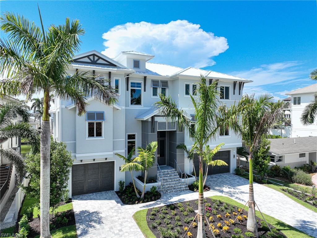 This just completed 3 story Connors Vanderbilt home by DCS offers it all, Beach-Boating-Amazing Furnished Home, you don’t have to wait 2 to 3 years to design, engineer, permit, build & furnish -just move in.  This Coastal Design home’s outstanding floor plan is the result of 20+ years of designing & building luxury waterfront spec homes & includes all concrete construction, impact windows & doors, elevated swimming pool & spa, new sea wall, a dock to accommodate a large boat w/16,000 lb lift, 6 plus car garage, elevator, whole house generator, smart home technology, electric screens & shutters and best of all it’s location right across the street from the dedicated beach access.  Interior features: open kitchen dining grande room sliders to the elevated pool, spa, sun deck and covered lanai w/summer kitchen, fireplace & tv, 4 bedrooms, 7 baths, large waterfront office, oversized flex room w/full bath, sit at bar, wine wall, pool table that doubles as a second dining table, large outdoor deck for sunsets & long canal views & unrivaled master suite. The high quality of finishes include detailed millwork, ceiling details, hardwood flooring, tile selections, cabinetry & appliances.
