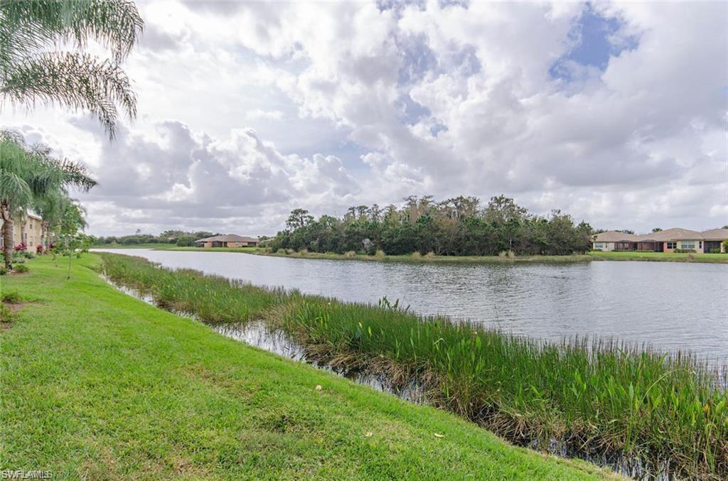 Fabulous LAKE view, NO STAIRS! Rarely available "Camelia" floor plan, the largest & most desirable in the community! IMMACULATE 2+Den, first floor END UNIT! Upgraded Granite kitchen and baths, Stainless appliances, diagonal tile all throughout. Carport w/additional locked storage. Very accommodating for a winter retreat or vacation getaway. There's something special at Bella Terra for everyone, a great place to enjoy upscale living... especially in this affordable price range. Top notch amenities as you'd expect in exclusive country clubs, including guarded gate house, fabulous Resort-style clubhouse, pool & spa, 24H fitness center, on-site activities director, secured children's play area, sand volleyball courts, bocce & tennis courts, basketball, even an in-line skating rink. Located in central Estero near I-75, Florida Gulf Coast University, Miromar Outlets, library, restaurants, Convenient to SW FL International airport, beautiful SW FL beaches, Coconut Pointe & Gulf Coast malls, movies & so much more! Furnishings negotiable. Subject to 2018 seasonal lease, buyer receives $3000/mo. income!