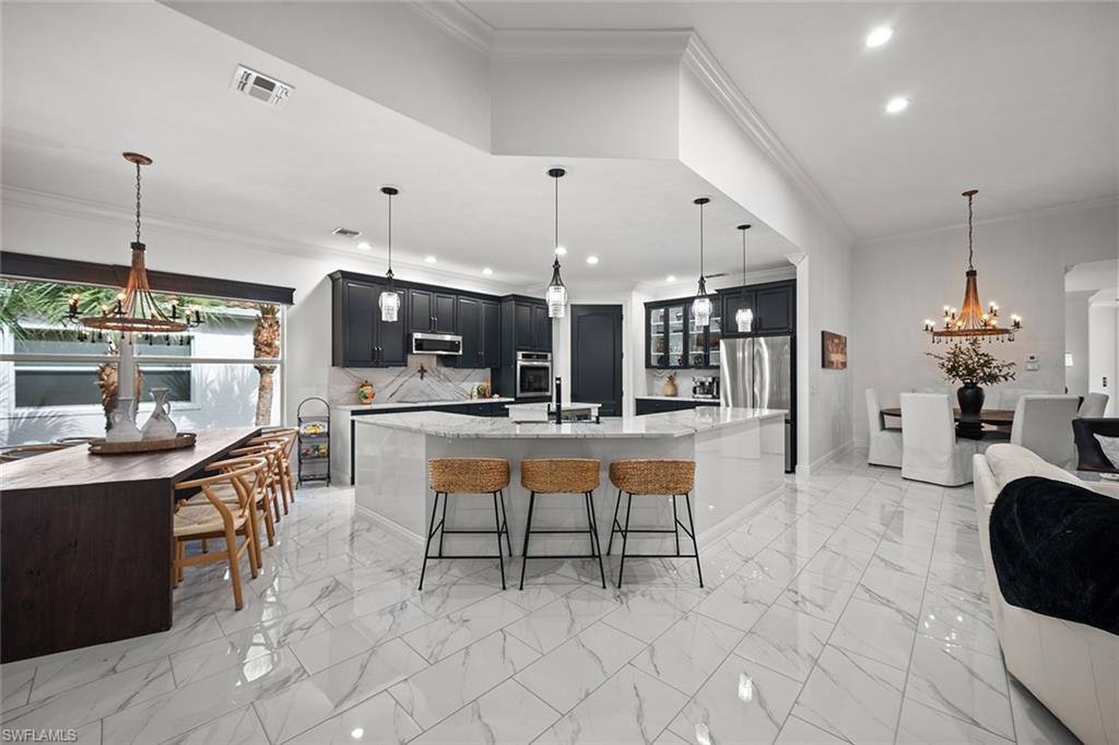 Luxury, light, and style come together in this exceptional Altessa at Vasari residence. This exquisitely renovated 3-bedroom + den, 2 full bath, 1 half bath second-floor condo offers the perfect blend of sophistication, comfort, and effortless Florida luxury. Light, bright, and beautifully updated throughout, the residence showcases porcelain tile in the main living areas and luxury vinyl flooring in the guest bedrooms, creating a refined yet relaxed ambiance. At the heart of the home is a spacious chef’s kitchen designed to impress, featuring stainless steel appliances, generous cabinetry, and abundant workspace for both everyday living and elegant entertaining. The open-concept floor plan flows seamlessly into the main living and dining spaces, enhanced by natural light and a fresh, modern aesthetic. The versatile den offers the ideal space for a home office, media room, or additional guest retreat. Every detail of this home has been thoughtfully refreshed to deliver a move-in-ready experience with timeless appeal. Set within the sought-after bundled golf course community of Vasari Country Club, residents enjoy an exceptional lifestyle with resort-style amenities and the convenience of luxury living in one of Bonita Springs’ most desirable locations.