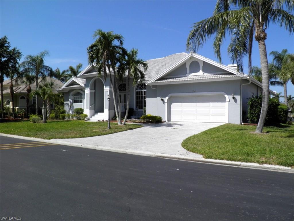 Gorgeous sunset view over wide canal in unique, small boating community with both 100+ acre fresh water lake for skiing, jet skis, fishing, sailing, and direct gulf access canal about 25 minutes to the Gulf. Custom 3 bedrooms, 2 and a half baths with solar pool and spa.  Open floor plan with large windows capturing nature's beauty and cozy fireplace.  New roof 2017, pool cage and equipment, new A/C 2017,  5,000 lb lift with new cables on dock with cemented pilings for up to 22' boat. Newly painted inside and out with new carpet.  Walk or bike about 3 miles around the lake, playground and beaches for the kids, tennis courts and pool in this family friendly community with tall trees and winding street. Close to airport, shopping, hospitals and Florida's famous white sand beaches.