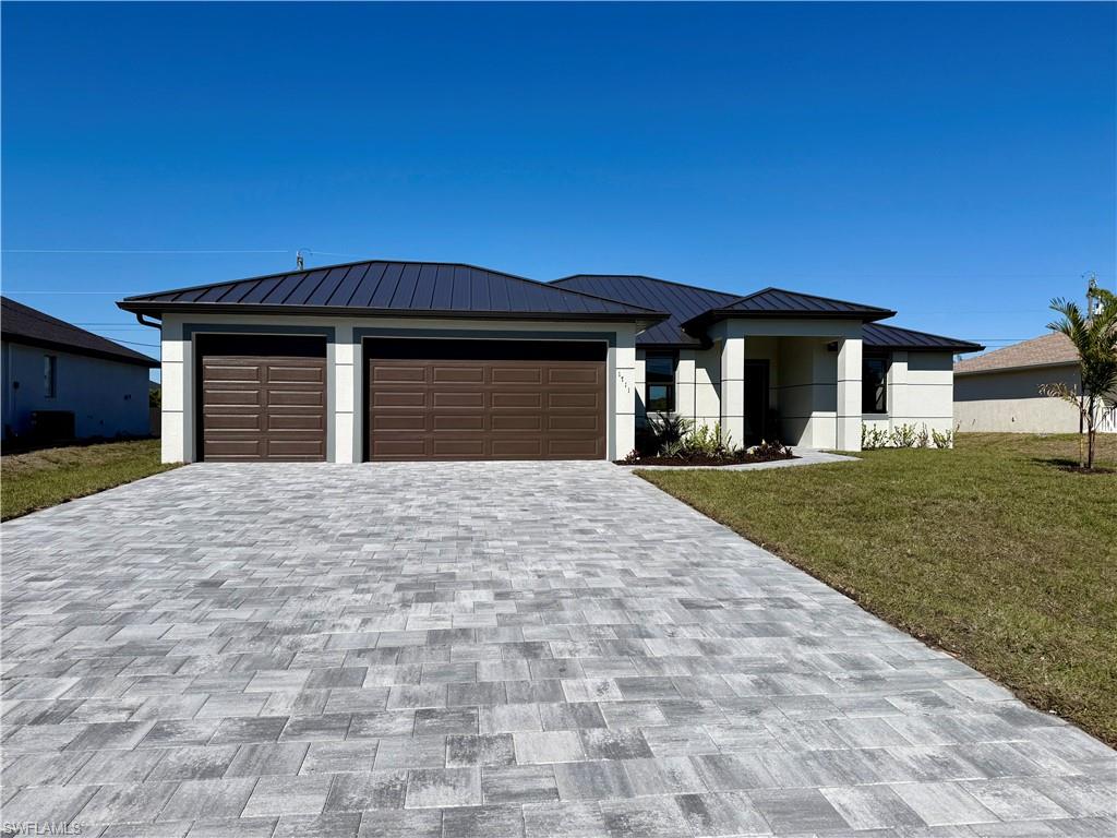 Luxury Waterfront Paradise with Heated Pool, Spa & 3-Car Garage | Brand-New 2026 Cape Coral Home!

Experience the ultimate Florida lifestyle in this breathtaking 2026 newly built canal-front masterpiece located in one of North Northeast Cape Coral's most sought-after neighborhoods. Perfectly positioned in a No Flood Zone with city water and sewer, this exceptional residence combines modern luxury, elegant design, and resort-style outdoor living. From the moment you arrive, you'll be impressed by the home's striking curb appeal, featuring a durable metal roof, professional tropical landscaping, and an oversized 3-car garage. Inside, soaring 12-foot vaulted ceilings, expansive living spaces, and beautiful neutral tile flooring create a bright, sophisticated atmosphere designed for both everyday comfort and grand entertaining.

The heart of the home is a stunning chef-inspired kitchen showcasing a massive quartz waterfall island, custom white shaker cabinetry with warm wood accents, designer pendant lighting, matte-black fixtures, premium stainless-steel appliances, and a built-in butler's pantry complete with a wine refrigerator. Large panoramic sliding glass doors seamlessly connect the indoor living space to your private outdoor oasis.

Step outside and discover true resort-style living with a screened heated pool and spa, expansive paver lanai, and a fully equipped outdoor kitchen overlooking the peaceful canal. Whether you're hosting guests or enjoying a quiet evening sunset, this backyard retreat delivers the perfect blend of luxury and relaxation. The spacious primary suite is a private sanctuary featuring direct lanai access, a custom walk-in closet, and a spa-inspired bathroom with dual quartz vanities and an oversized glass walk-in shower. A thoughtfully designed split-bedroom floor plan includes a second private suite with pool access, plus two additional guest bedrooms, making it ideal for families, visiting guests, or multi-generational living.

Additional highlights include impact-resistant doors and windows, a beautifully appointed laundry room with custom cabinetry and utility sink, premium finishes throughout, and exceptional attention to detail at every turn. Why vacation once a year when you can live like you're on vacation every day? Schedule your private tour today and discover one of Cape Coral's finest waterfront rental opportunities.