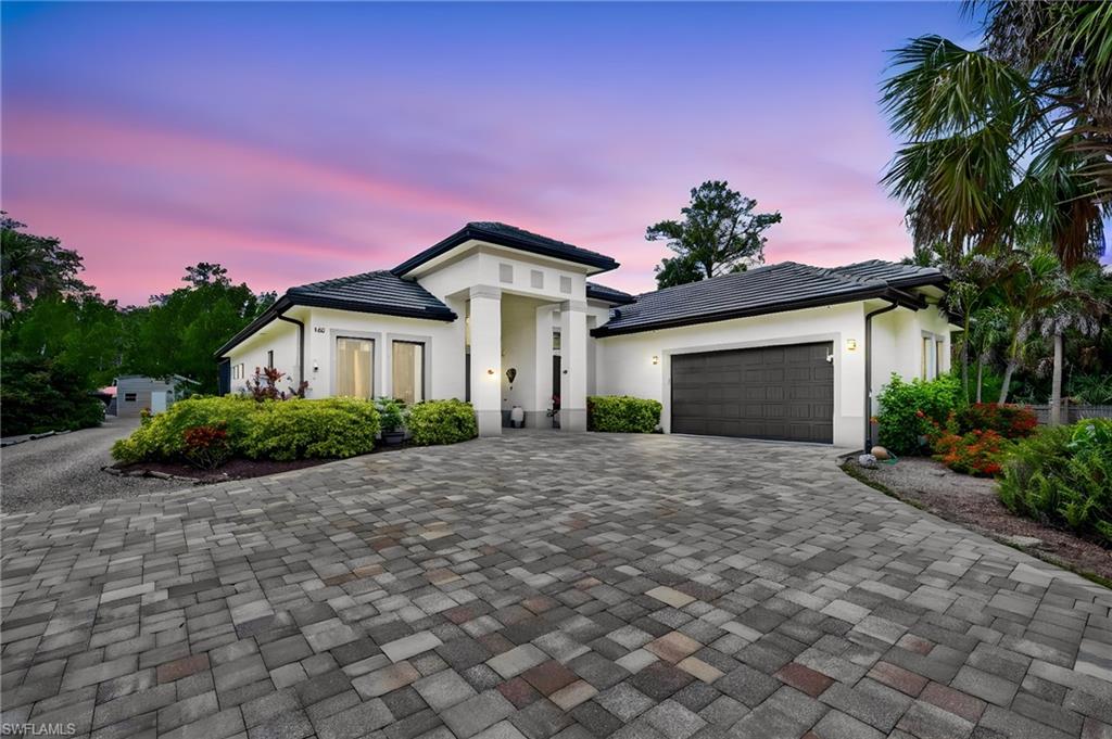 LUXURY 2.5 AC GATED-UPSCALE-LUXURY ESTATE HOME! THIS STUNNING UPGRADED ($350,000+/-) & RENOVATED 4 BEDROOM, 3 BATH, SALT-SYSTEM HEATED POOL, 5+ CAR ATTACHED & DETACHED GARAGES AND WORKSHOP! Super CURB APPEAL and as you enter through the front electric gate and wind thru the long PAVER driveway, you immediately get a STRONG SENSE, how beautiful and UNIQUELY DIFFERENT this property is. The 2.5 acres has been landscaped, fenced, cleared and cared for and carry's that through the entire property.  Big front double door entry, all 18"x18" IMPORTED SPANISH PORCELAIN TILES, creates a "CALMING FLOOR" feel through the entire home. VOLUME 14' TRAY-ED CEILINGS all accented with CROWN MOLDING THROUGHOUT. "CHEFS" KITCHEN with Custom White "SHAKER" Wood Cabinetry (with pull-outs-soft close), Level 5 GRANITE TOPS, All High-End Stainless Steel "WHIRLPOOL" Appliances. Lots of glass windows and sliders and all are HIGH "IMPACT" STORM RESISTANT and with these so much of the sunshine is captured keeping the home LIGHT-BRIGHT-SUNNY all year round. MASTER BEDROOM has 14 soaring ceiling, HIS & HERS large WALK-IN CLOSETS (all with wood organizers), dual QUARTZ SINKS and vanities, jetted SOAKING TUB AND huge GLASS & TILE WALK-IN SHOWER with double "RAIN-HEADS". Huge screened Lanai finished in SKID-PROOF TILE for the SAFETY. The entire POOL DECK is finished with PAVER STONE and wraps around a HUGE OVER-SIZED CUSTOM HEATED POOL with WATERFALL features. A SUMMER KITCHEN for those pool side family and friends' gatherings.  Further back of the pool a wide gravel road walks you back to the WORKSHOP (40'x25'), with a finished EPOXY FLOOR, which can store ADDITIONAL CARS if you are a collector, RV, BOAT or run your business from the finished area built out as a BAR, MANS CAVE, CAFE', however you like it, is A/C AND HAS BOTH 12' FRONT AND REAR ROLL-UP DOORS for convenience of moving vehicles or boats in and out. Home has a complete property STAR-LINK CAMERA SYSTEM, REVERSE OSMOSIS WATER FILTRATION SYSTEM, WHOLE HOUSE GENERATOR SET-UP WITH 500 GALLON IN GROUND TANK AND ELECTRICAL CONNECT BOX IN PLACE. Here is some very important information: THE NEW PLANNED THRU CONNECT FROM GOLDEN GATE BLVD TO VANDERBILT BEACH ROAD, is right nearby on 13th street. This home has no standing water year-round. Owner built this custom home with 52 loads of fill dumped and compacted so no standing water or mosquitos, how about that special feature. HOME COMES WITH ONE YEAR "HOME WARRANTY" FOR TOTAL BUYER COMFORT! This home is a very RARE FIND in the Estates. The quality of the construction and finishes set it apart. IT IS ONLY FOR THE VERY DISCERNING BUYER, who wants the very best for his family!