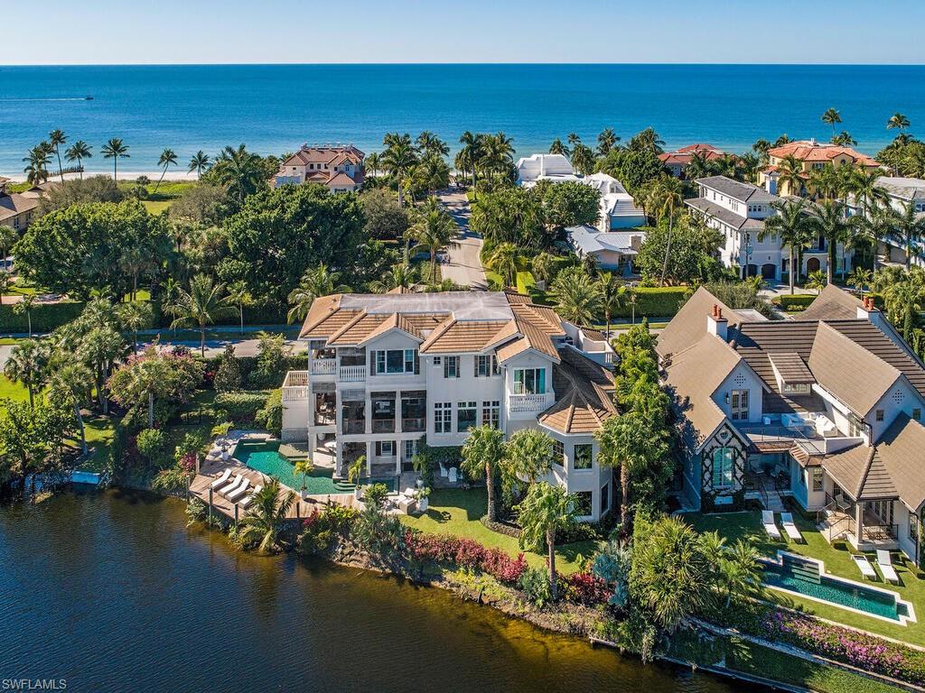Located two homes to the beach lies a property unlike any other in Old Naples. The parcel location and shape has afforded a design that features sweeping lake front views from every room. Attention to detail and high level of finish throughout, enhanced by multiple outdoor terraces seamlessly put the water vistas as the focus. Serene and private, with walls of glass allowing unimpeded eastern and western light.  A one of a kind opportunity mere steps to the Gulf of Mexico and a quick stroll to the renowned 5th Avenue shopping and dining.