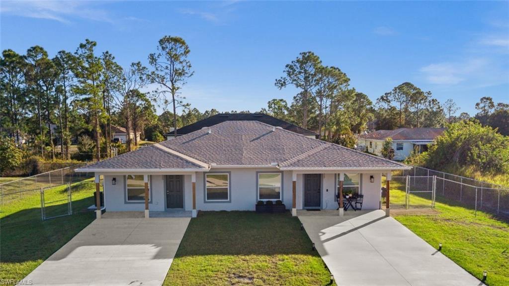 Opportunity awaits in Lehigh Acres! 915/917 Graystone Avenue is a newer-construction duplex built in 2024, offering a solid opportunity for rental income or owner occupancy in a growing Lehigh Acres area. The property features tile flooring throughout, in-unit laundry for both sides, and separate fenced backyards that offer the chance to create a private outdoor retreat, whether that means space for pets to roam and play, room to enjoy the outdoors, or a quiet spot to unwind at the end of the day. Each unit includes three bedrooms, with a primary bedroom offering an en-suite bath and walk-in closet, along with a well-appointed kitchen finished with granite countertops, wood cabinetry, and stainless-steel appliances that make everyday living comfortable and functional. Live on one side and rent the other or use as an investment property. This is an immediate income producer, with unit 915 rented for $1540 per month through March 2027. Located in Flood Zone X (no flood insurance necessary) and with impact windows and doors throughout, this property offers added peace of mind for years to come. Conveniently positioned near parks, shopping, dining, and major roadways with easy access to Fort Myers and surrounding areas. Don't miss out on this opportunity. Make your appointment to see 915/917 Graystone Avenue today!