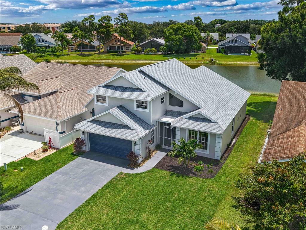 Welcome to this beautifully updated two-story home in the highly desirable Islands at Three Oaks community! Offering nearly 2,300 square feet of living space, this LAKEFRONT move-in-ready residence features 4 bedrooms, 2.5 bathrooms, and a floorpan to fit many lifestyles.  From the moment you enter, you'll be impressed by the soaring ceilings and abundance of natural light that create an open and inviting atmosphere. The home has been extensively updated with fresh interior and exterior paint, brand-new carpeting, stylish light fixtures, updated hardware, and a stunning new kitchen featuring white shaker cabinetry with soft-close doors and drawers, gorgeous Corian countertops, and stainless-steel appliances. The spacious first-floor primary suite offers a private retreat with dual updated vanities, a relaxing jetted soaking tub, separate walk-in shower, and ample closet space. Upstairs, you'll find additional bedrooms and living space to accommodate family and guests comfortably. Step outside to the oversized screened lanai, offering plenty of room for outdoor dining, entertaining, and relaxing while enjoying the beautifully landscaped backyard. Lush tropical landscaping surrounds the home, enhancing its curb appeal and creating a peaceful setting. Located in one of South Fort Myers' most sought-after communities, this home is conveniently situated near shopping, dining, entertainment, RSW International Airport, and schools. With school starting soon, now is the perfect time to make your move and enjoy everything this exceptional home has to offer!
