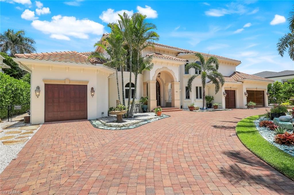 Live the Ultimate COASTAL LIFESTYLE in The Moorings!

Discover an opportunity to own nearly 4,000 sq. ft. of coastal luxury in one of Naples’ most coveted neighborhoods—THE MOORINGS—just minutes from the Gulf. Impeccably designed with no detail spared, this show-stopping residence blends sophisticated design with effortless functionality. With a grand GROUND-FLOOR PRIMARY SUITE, it’s gracious, easy living at its VERY BEST!

Step into the heart of the home: a NEW chef-inspired KITCHEN with high-end appliances including a VIKING Stove with six gas burners, griddle, and two ovens, a Viking refrigerator, BOSCH dishwasher, an elegant butler’s pantry & a custom coffee/bar station with wine cooler. From vaulted ceilings and crown moldings to the sweeping staircase rising from a grand foyer, timeless architecture meets modern flair.

The floor plan offers FOUR EN-SUITE BEDROOMS, a home OFFICE, a bonus LOFT, and TWO POWDER ROOMS. The FIRST-FLOOR PRIMARY SUITE is a true sanctuary, featuring a spa bath, a walk-in closet, and a serene pool access with a tropical view. Step outside into your BACKYARD OASIS, designed for year-round entertaining. Enjoy a heated SALTWATER POOL and spa, OUTDOOR KITCHEN with icemaker and refrigerator, tropical landscaping, & a fire pit that invites evenings under the stars—all behind a fully fenced yard that ensures privacy with ambiance. The 4-CAR GARAGE with mini-split air conditioners is incomparable. As a resident of The Moorings, you’ll have the option to join the Moorings Property Owners Association, offering private BEACH ACCESS, dedicated parking, & a dining pavilion STEP FROM THE SAND.

Whether you’re hosting friends, savoring quiet luxury, or catching sunsets at the beach, this home delivers the ultimate Naples lifestyle—elegant, effortless, & most EXCEPTIONAL!