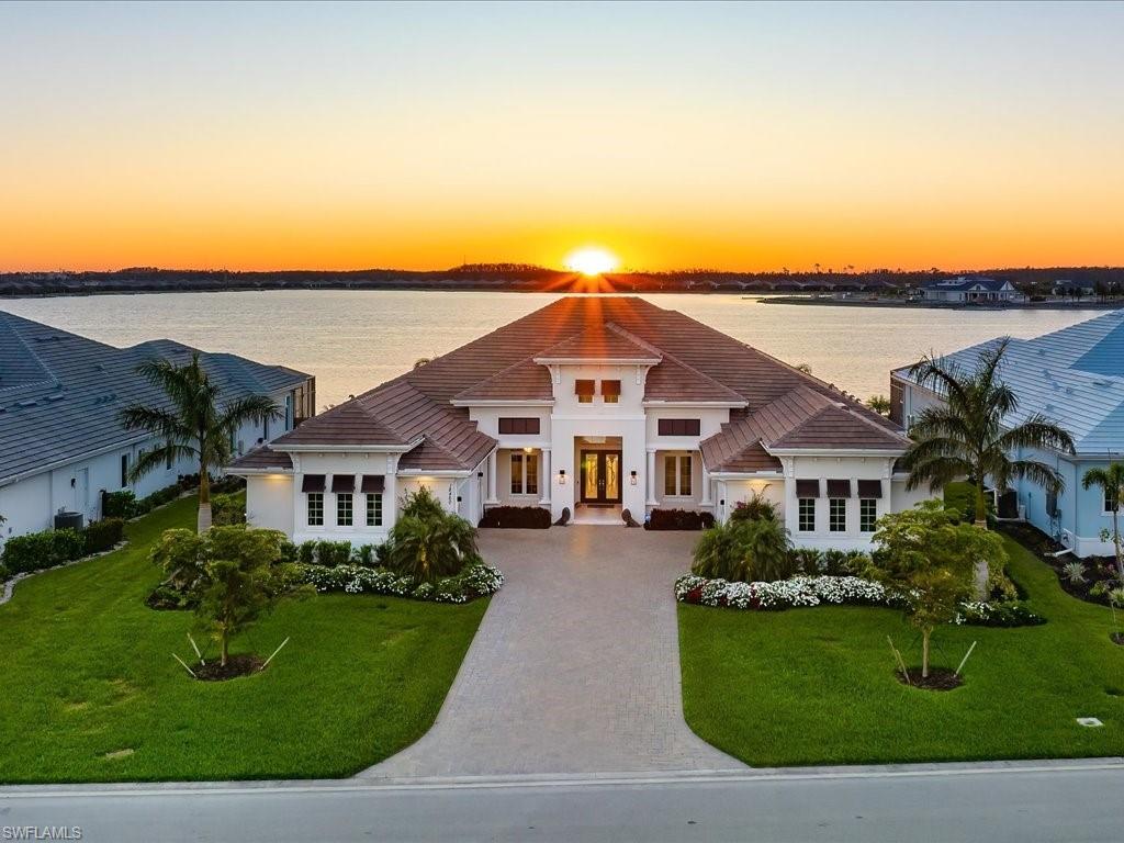 From The Moment You Step Inside "Sunset Solitude", You Are Graced W/ Magnificent & Seemingly Endless Western Lake Views. This Luxurious Customized Clairborne II Estate Home Sits On 1/2 Acre Lot, W/ 1100 Sqft. Of Outdoor Living, Making It Ideal For Entertaining. The Kitchen Offers Thermador & SubZero Appliances, Marvel Wine Fridge, & Mitred Quartz Island Countertops Which Is Home To 2 Dishwashers. The Custom Master Bathroom Includes His & Her Water Closets, Dual Shower Heads In Shower, Separate Soaking Tub, His & Her Sinks And Vanity Seat. Other Amazing Features Include Quartz Countertops Throughout, Lutron Shades, Sonos Sound System, Whole House Generator, RO System, Hurricane Impact Windows/Doors & Two 2-Car Garages That Are Both Insulated & Air Conditioned. Your Outdoor Living Offers You A Custom Saltwater Pool W/ Oversized Spa, Gas Fireplace, TV, Outdoor Kitchen W/ NatureKast Cabinetry, Sedona (Lynx) Built-In Gas Grill, Marvel Wine Fridge, Four Different Sitting Areas, All Of Which Can Be Enclosed W/ Electric "In-Wall" Hurricane Shutters To Lock Down When It’s Time To Leave. Electric & Water Already Installed For Your Future Private Dock On The Lake Out Back If Desired.