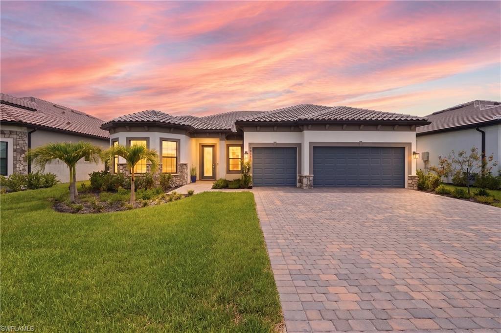 Poolside perfection and a brand-new outdoor kitchen have arrived in Verdana Village. This coastal modern Stellar home was designed to impress, blending luxury finishes, thoughtful design, and resort-style living. Negotiable furnished, this exceptional move-in ready residence offers 3 bedrooms plus a designer den, 3 bathrooms, saltwater pool, tranquil pond views, and a 3-car garage. Every detail of this home has been thoughtfully selected to create warmth, function, and timeless style. From the moment you enter, the bright open-concept layout welcomes you with elegant tray ceilings, designer lighting, custom finishes, and expansive living spaces ideal for entertaining and everyday comfort. The gourmet kitchen serves as the heart of the home featuring an oversized furniture-style island with seating, built-in stainless appliances including a gas cooktop, wall oven, and microwave, quartz countertops, modern white backsplash, recessed & pendant lighting, spacious walk-in pantry, and wine rack with beverage fridge. The living room has been enhanced with a custom entertainment wall, built-in storage, designer window treatments, and curated coastal-modern details throughout. The den has been transformed into a stunning office complete with custom built-ins, integrated desk and drawer storage, statement wallpaper, elegant sconces, and chandelier lighting creating a workspace that is both functional and beautiful. The spacious primary suite serves as a true private retreat overlooking peaceful pond and pool views, while the split-bedroom floorplan offers comfort and privacy for guests and family. Designer details include a custom accent wall, pendant lighting, oversized walk-in shower, dual sinks with quartz countertops, linen closet, and expansive walk-in closet creating a spa-inspired atmosphere. Outdoor living is where this home truly shines featuring a saltwater pool, newly completed outdoor kitchen, covered entertaining areas, and relaxing water views creating the ultimate private retreat. Additional features include impact windows and doors, smart home technology with Ring doorbell and smart garage access, mudroom, laundry room, transferable structural warranty, and a epoxy garage floors and EV charging outlet. Verdana Village continues to stand out as one of Southwest Florida’s most exciting resort-style communities featuring a 24-hour guard-gated entrance and unmatched lifestyle experience. Residents enjoy indoor and outdoor pickleball and tennis courts, bocce courts, indoor basketball courts, and a tennis pro shop within the state-of-the-art sports complex. The community also offers a resort-style pool and spa, Paradise Pool bar, craft cocktail lounge, café and restaurant, fitness center, yoga lawn, dog park, playground, scenic walking trails, and golf cart-friendly living. Located minutes from RSW Airport, shopping, dining. Verdana Village continues to attract buyers seeking luxury and an active coastal lifestyle. Walk in and fall in love.