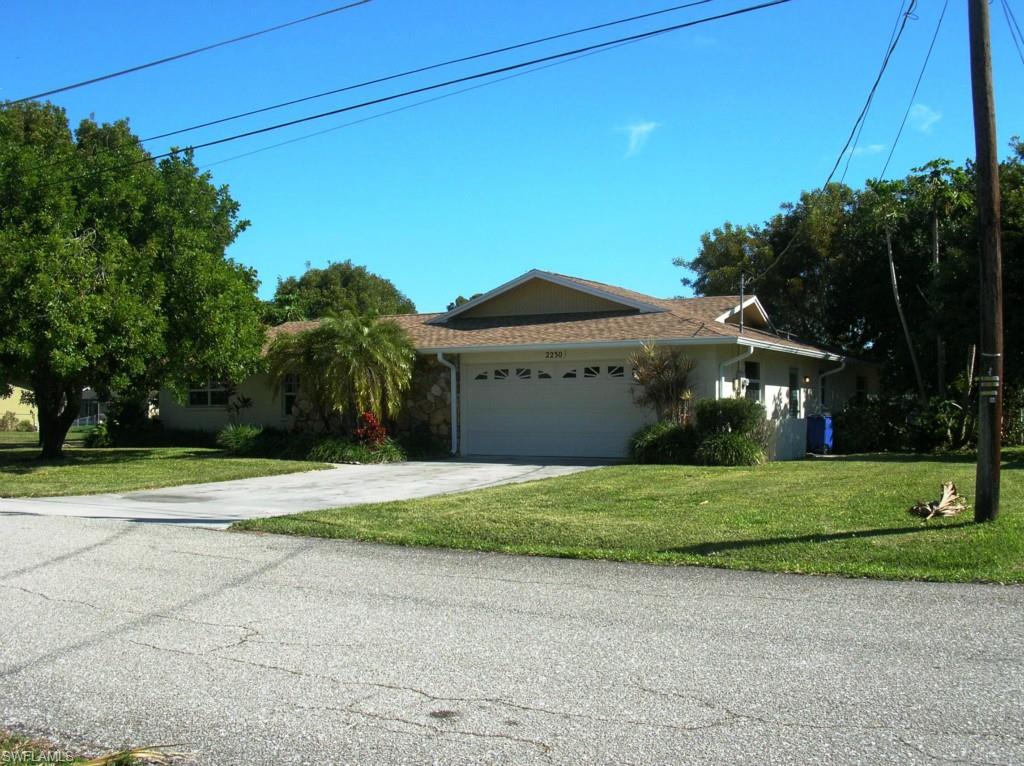 Immaculate, Well-maintained large 2000 sf home under air on a wide, deep sail boat access direct gulf access canal.  There are 3 large bedrooms, 2 baths, a den with fireplace, boat dock and lift.  The seawall is concrete and in good shape.  The lost size is 150 ft on the canal and 124 ft. deep.  The roof, sofits and gutters new in 2014.  The interior has been newly painted and carpets cleaned.  The kitchen was updated with all wood cabinets and corian counter tops.  The garage is extra large and easily accommodates two cars with plenty of room left over for tools and storage.  The location is within two blocks of a county maintained park with boat ramp. Its easy to put the boat in for the weekend then take out when your finished.  There is a second concrete drive for RV parking.  PLUS!!! a 60 Ft wide building lot on the waterfront could be split from the property an sold separately.