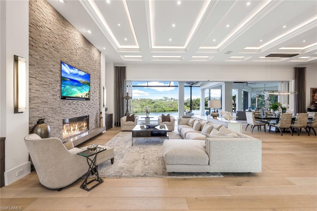 Fall madly in love with this 2017 custom built estate style home in Oak Knoll of Bonita Bay. This exceptional home is nestled on one of the community’s most coveted & private lots, offering unparalleled seclusion & tranquility. Surrounded by lush landscaping & natural beauty, this prime location ensures that residents enjoy both privacy & scenic views. This ONE OF A KIND STUNNING HOME offers impeccable high-end finishes, including wide board oak floors, custom ceiling treatments, & an expansive private long lake view. The indoor area is absolutely gorgeous with a large great room, a bar, & hurricane sliders that automatically open with the touch of a button. Enjoy seamless indoor-outdoor living w/a heated infinity edge pool, spa, fire bowls, a fire top table, marble pavers & so much more. The lanai boasts an outdoor kitchen w/an Alfresco grill, motor-driven retractable panels, & electronic storm shutters. The home features a Generac generator, 3 new central A/C systems (2022, 2023, 2024), Alini water filtration system, AAMI central alarm, Sonos sound system, & Lutron lighting. All doors &windows are hurricane-resistant providing protection &  peace of mind! The chef’s kitchen located in the great room is equipped w/Thermador appliances, a Subzero refrigerator/freezer, & Cristallo countertops. A separate bar area boasts a Subzero wine cooler, a Miele built-in coffeemaker, & a Thermador dishwasher. The spacious living room includes a feature wall w/a stunning custom fireplace, floating ceilings, & designer lighting. The primary suite offers a large sitting area w/lake views, 2 custom walk-in closets, motorized window shades, & a luxurious bath w/marble countertops & a HUGE walk in shower. Three guest bedroom suites accommodate king-size beds, each with its own beautifully designed bathroom. The den features custom cabinetry, motorized shades, & barn doors. 3 car garages include one 2-car and one single-car, both w/Mitsubishi A/C units & custom cabinetry. If you desire a newer, ultra modern, yet cozy home, a PRIVATE lot, TRUE indoor/outdoor living, & tons of space for all in the desirable community of Bonita Bay, look no further! Experience unparalleled elegance & comfort in this extraordinary residence!  Bonita Bay offers an array of exceptional amenities, including a private beach club, kayaking, canoeing, pickleball, tennis, & multiple community parks. Explore over 12 miles of walking & biking paths, or take advantage of the full-service marina & restaurant. Golf enthusiasts will appreciate the FIVE on-site courses, complemented by several dining options, a state-of-the-art fitness center, & more--all available with club membership (addl fees apply). A short drive from world-class dining, shopping, beaches, & nature preserves, you'll also enjoy easy access to the burgeoning downtown Bonita Springs & downtown Naples. RSW Intl Airport is conveniently nearby! Properties this gorgeous on such fine lots are RARELY available in Bonita Bay!