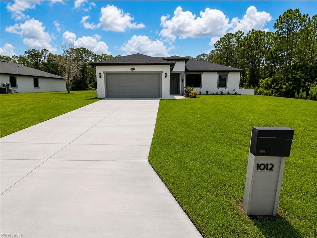LIKE NEW - MASSIVE HALF ACRE LOT - FULLY FENCED IN WITH METAL FENCING - TILE THROUGHOUT - GRANITE COUNTERTOPS - 4 BEDROOMS.  Welcome to a residence where contemporary craftsmanship, thoughtful design, and exceptional value converge. Built in 2025, this impeccably maintained 4-bedroom, 2-bath home offers 1,918 square feet of beautifully appointed living space and presents an outstanding opportunity to enjoy the benefits of virtually new construction—without the lengthy build time or uncertainty.
From the moment you enter, you'll appreciate the home's refined finishes and cohesive design. Elegant tile flooring extends throughout the entire residence, creating a seamless and sophisticated aesthetic, while matching granite countertops enhance both the gourmet kitchen and bathrooms with timeless style. The spacious primary suite serves as a private retreat, featuring dual granite vanities, a beautifully tiled walk-in shower, and generous his-and-her walk-in closets. High-end lighting and upgraded fixtures, both inside and out, further elevate the home's distinctive character.
Designed for effortless living and entertaining, this move-in-ready residence offers a bright, open interior that provides the perfect canvas for your personal décor and style. Every detail reflects quality, comfort, and enduring appeal.
One of the property's most remarkable attributes is its expansive double lot (1/2 acre). The enormous backyard is fully enclosed with durable 6-foot metal privacy fencing, offering exceptional security for children and pets while providing abundant space for outdoor recreation. There's ample room to create the pool of your dreams, and thanks to the oversized homesite, you'll still enjoy an impressive backyard after installation. The generously sized covered lanai offers a comfortable shaded retreat for relaxing or entertaining year-round.
Situated on a quiet, low-traffic street, this home delivers the peaceful setting families desire while remaining conveniently close to shopping, dining, schools, parks, and everyday conveniences.
If you've been searching for a home that combines upscale finishes, an oversized homesite, modern construction, and outstanding value, this exceptional property deserves your attention. Enjoy the confidence of owning a practically brand-new home without the wait—an extraordinary opportunity in one of Lehigh Acres' most desirable residential settings.